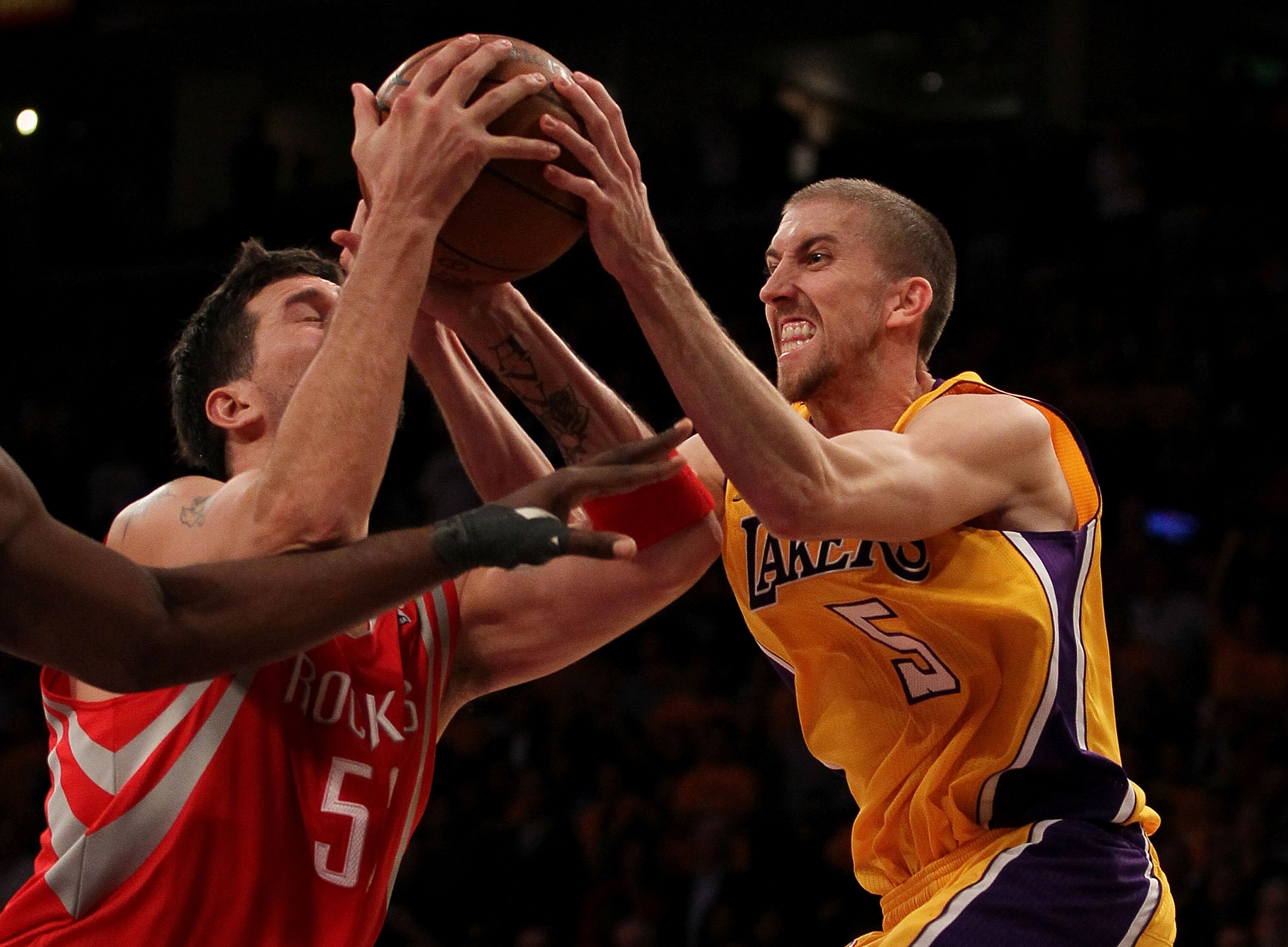 LOS ANGELES, CA - OCTOBER 26:  Steve Blake #5 of the Los Angeles Lakers fights for a rebound with Brad Miller #52 of the Houston Rockets during their opening night game at Staples Center on October 26, 2010 in Los Angeles, California. NOTE TO USER: User e