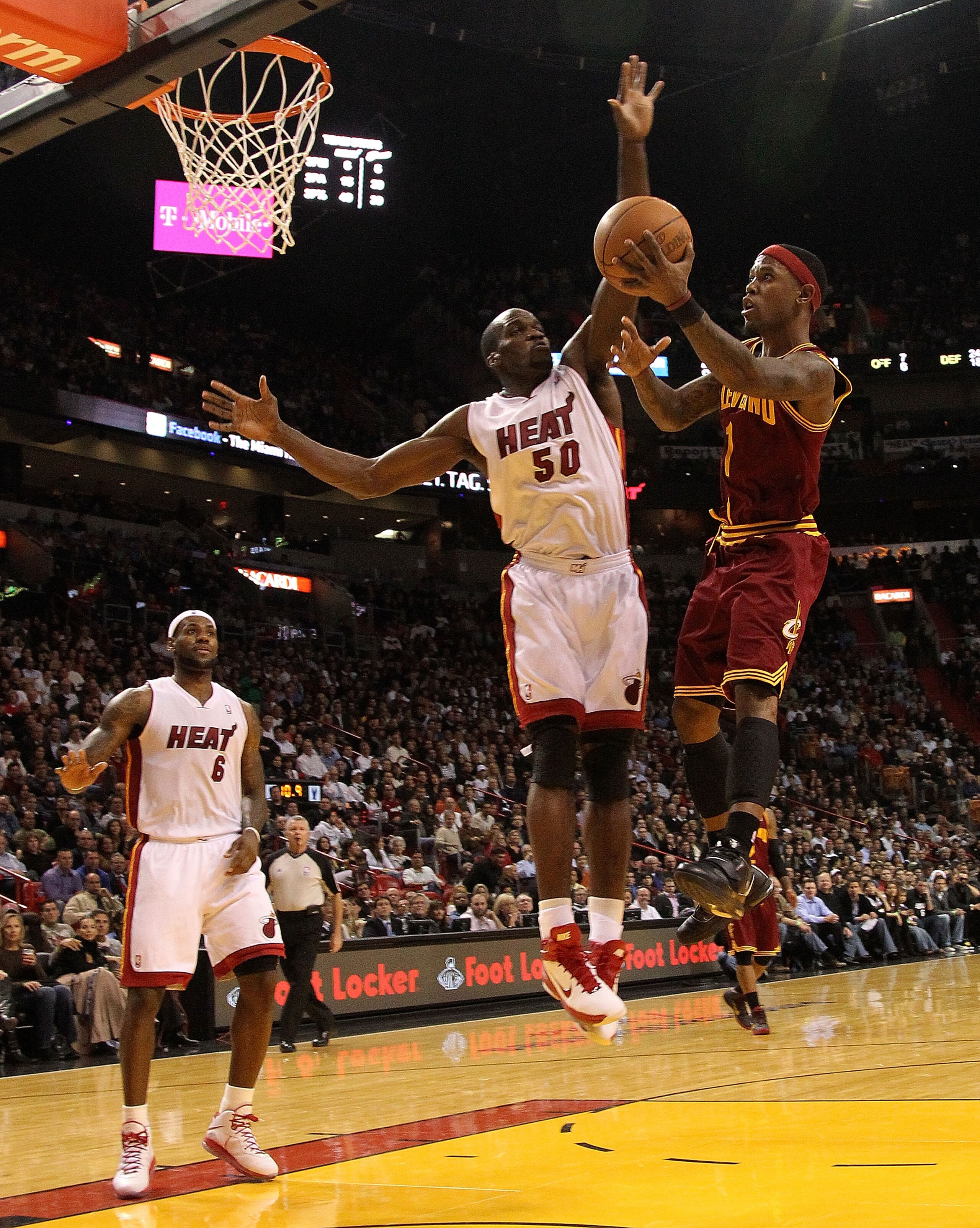 MIAMI, FL - DECEMBER 15:  Daniel Gibson #1 of the Cleveland Cavaliers is shoots over  Joel Anthony #50 of the Miami Heat during a game at American Airlines Arena on December 15, 2010 in Miami, Florida. NOTE TO USER: User expressly acknowledges and agrees