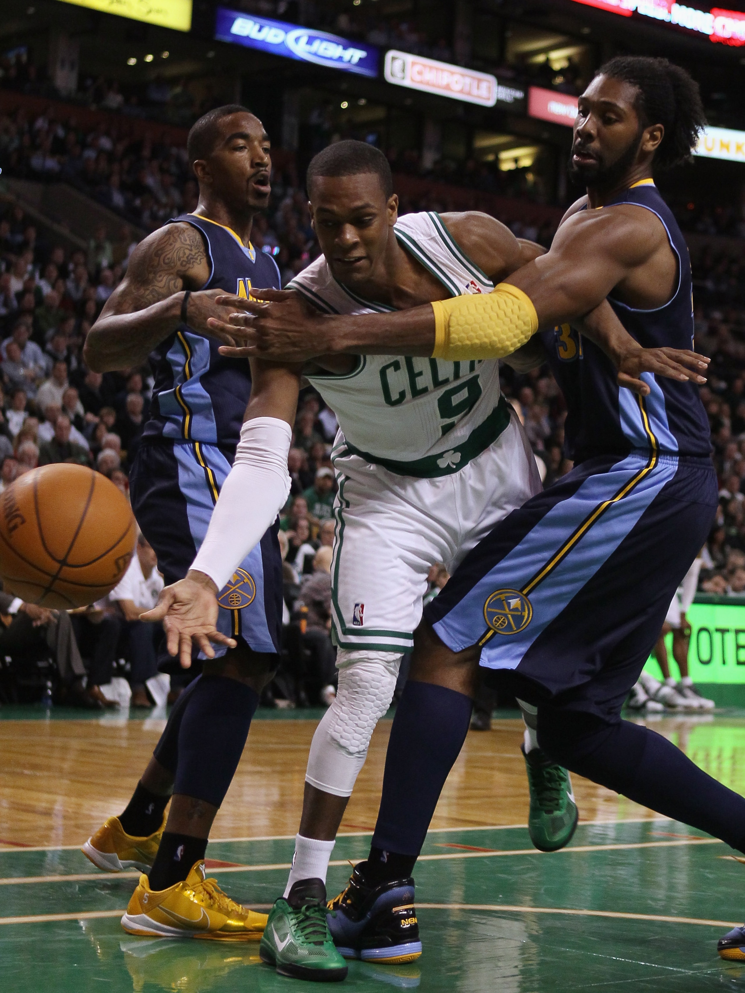 BOSTON, MA - DECEMBER 08:  Rajon Rondo #9 of the Boston Celtics tries to keep the ball as Nene #31 of the Denver Nuggets defends on December 8, 2010 at the TD Garden in Boston, Massachusetts. NOTE TO USER: User expressly acknowledges and agrees that, by d