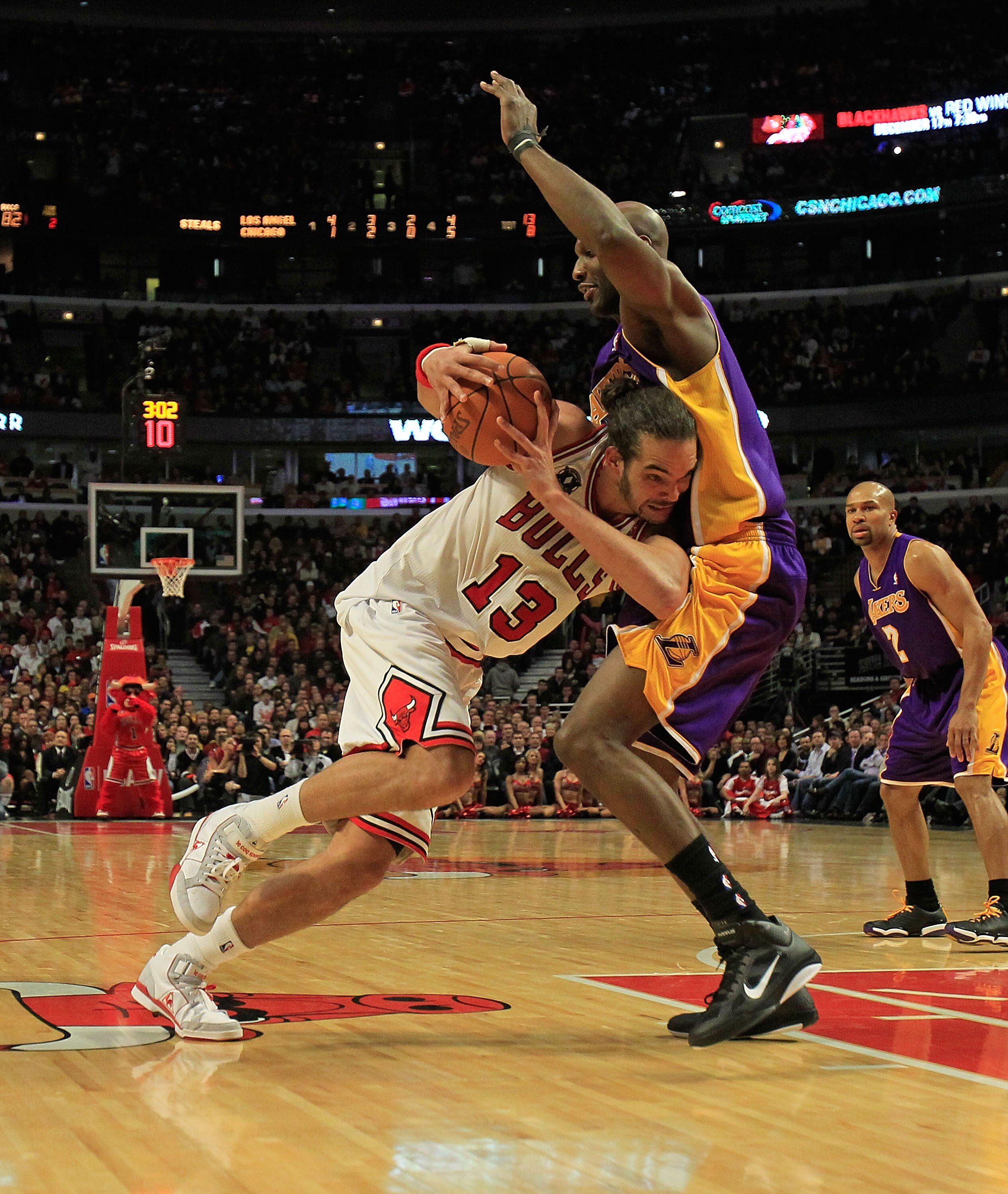 CHICAGO, IL - DECEMBER 10: Joakim Noah #13 of the Chicago Bulls drives against Lamar Odom #7 of the Los Angeles Lakers at the United Center on December 10, 2010 in Chicago, Illinois. The Bulls defeated the Lakers 88-84..NOTE TO USER: User expressly acknow