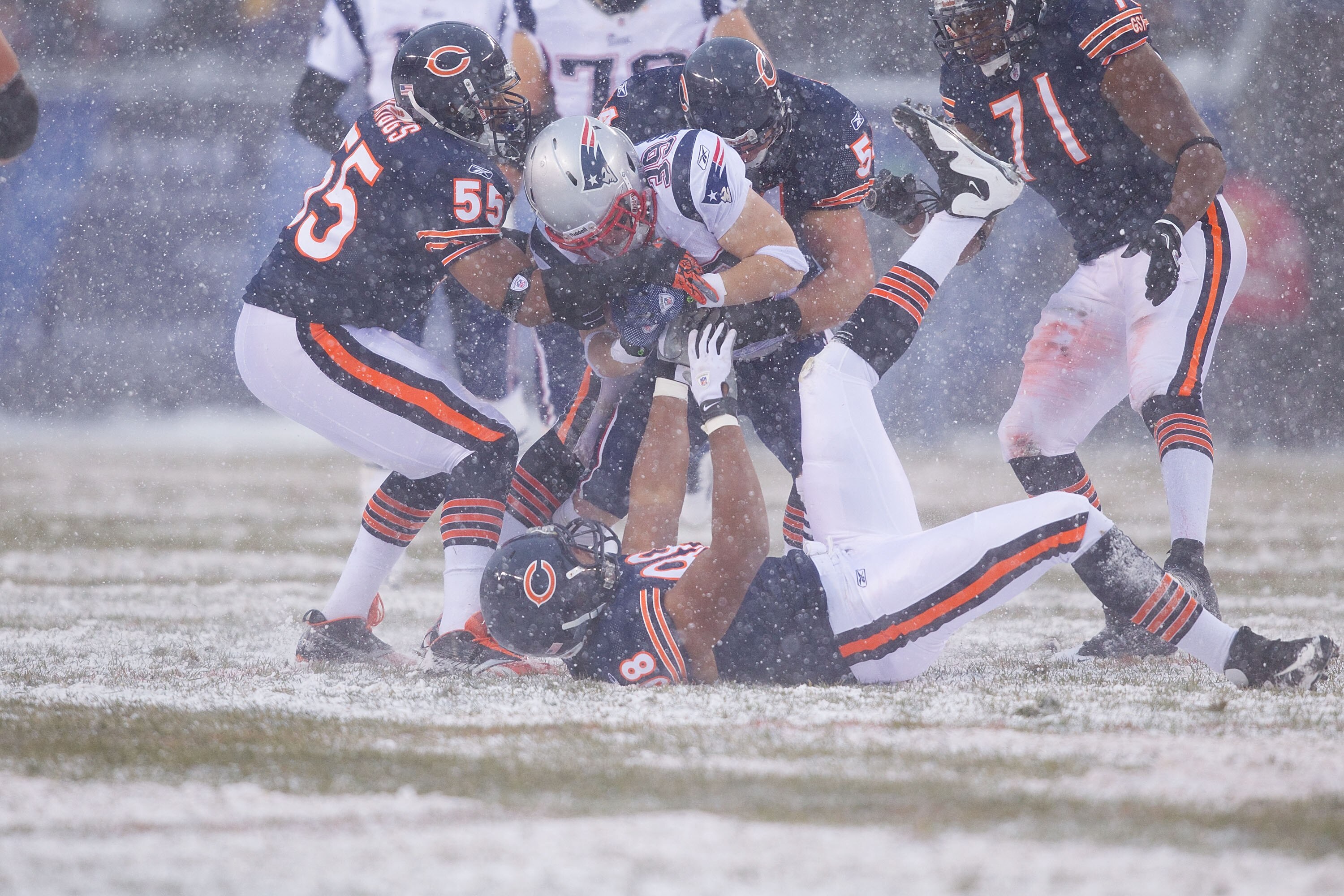 CHICAGO, IL - DECEMBER 12: Lance Briggs #55 and Brian Urlacher #54 both of the Chicago Bears tackle Danny Woodhead #39 of the New England Patriots at Soldier Field on December 12, 2010 in Chicago, Illinois.  The Patriots beat the Bears 36-7.  (Photo by Di