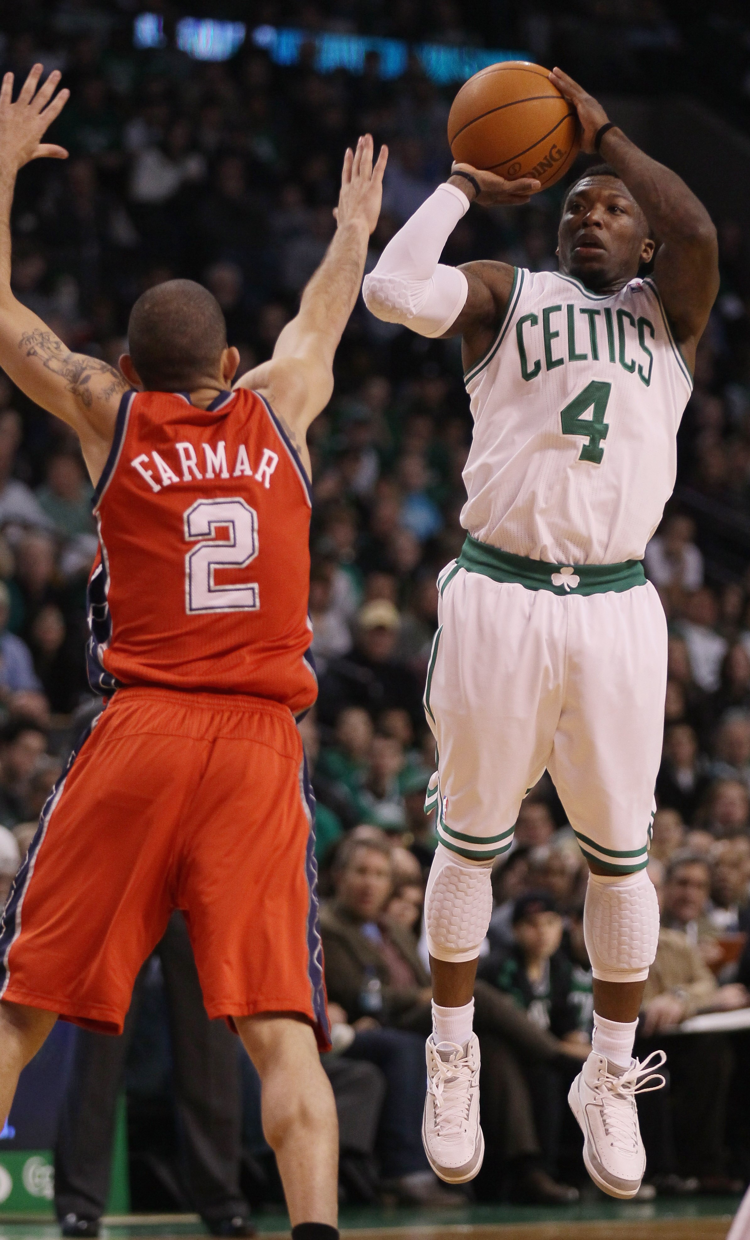BOSTON - NOVEMBER 24:  Nate Robinson #4 of the Boston Celtics takes a shot as Jordan Farmar #2 of the New Jersey Nets defends on November 24, 2010 at the TD Garden in Boston, Massachusetts. NOTE TO USER: User expressly acknowledges and agrees that, by dow