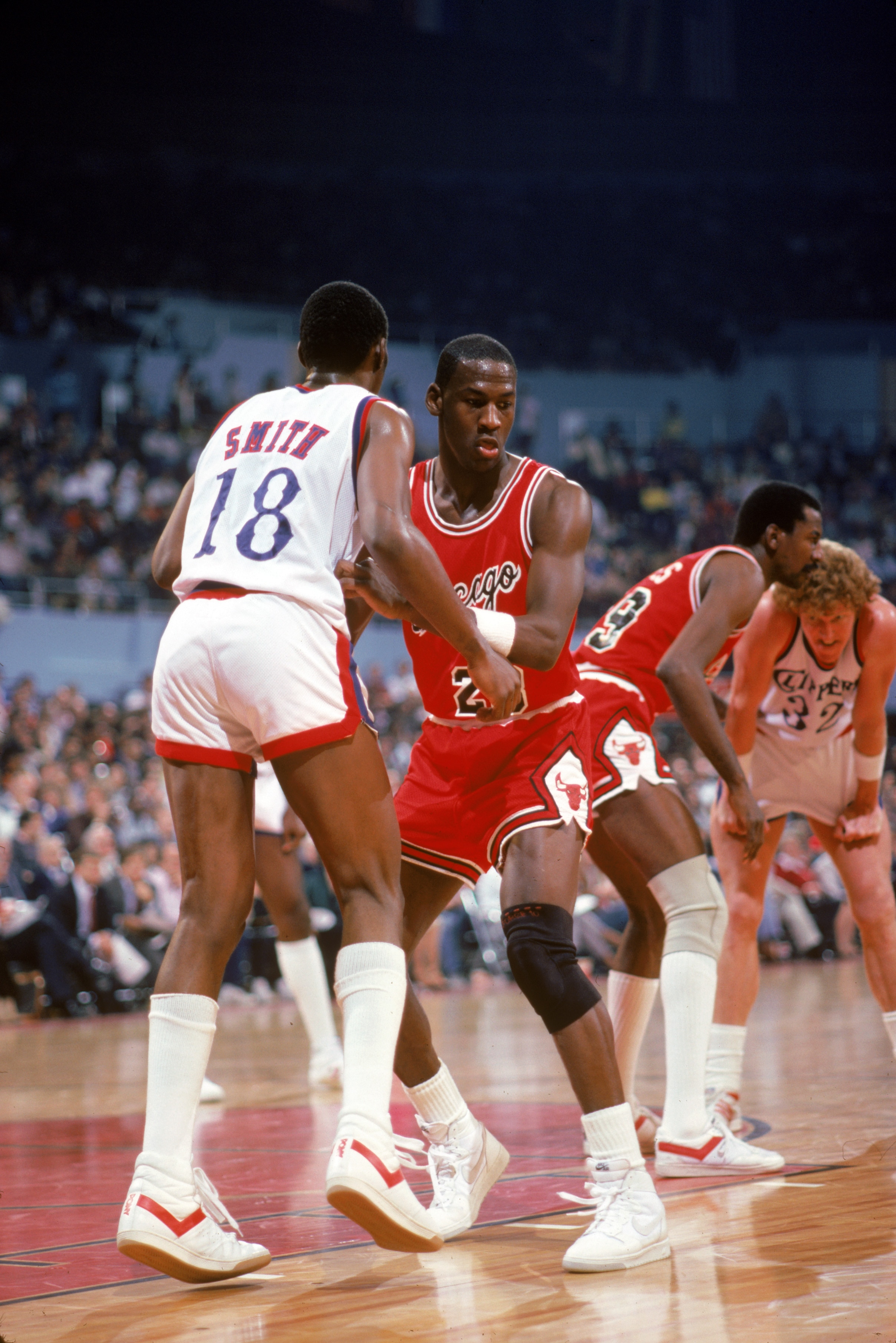 LOS ANGELES, CA -  - DECEMBER 1984:  Michael Jordan #23 of the Chicago Bulls defends Derek Smith #18 of the Los Angeles Clippers during a December 1984 season game at the Sports Arena in Los Angeles, California.  (Photo by Rick Stewart/Getty Images)