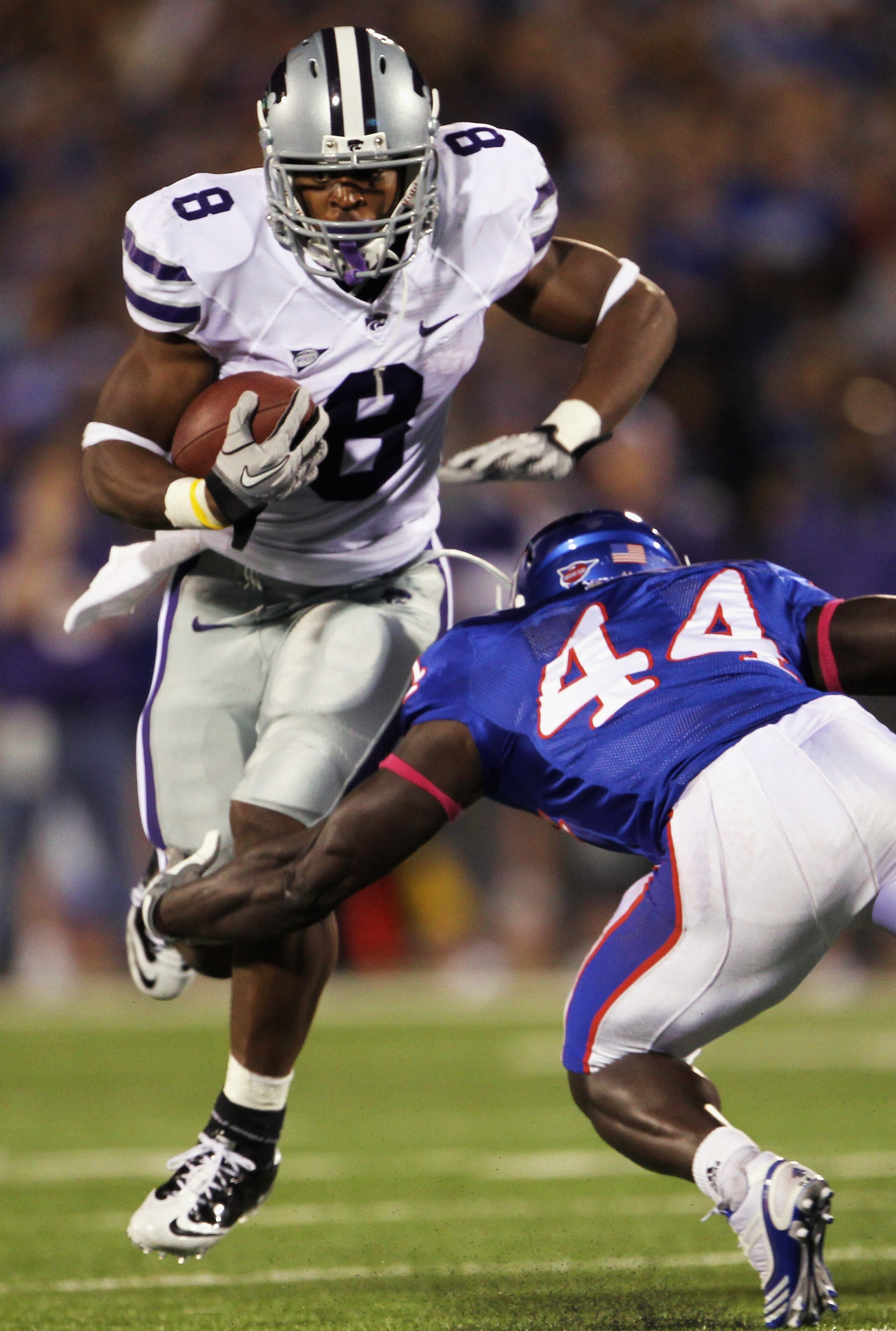 LAWRENCE, KS - OCTOBER 14:  Daniel Thomas #8 of the Kansas State Wildcats carries the ball as Olaitan Oguntodu #44 of the Kansas Jayhawks defends during the game on October 14, 2010 at Memorial Stadium in Lawrence, Kansas.  (Photo by Jamie Squire/Getty Im
