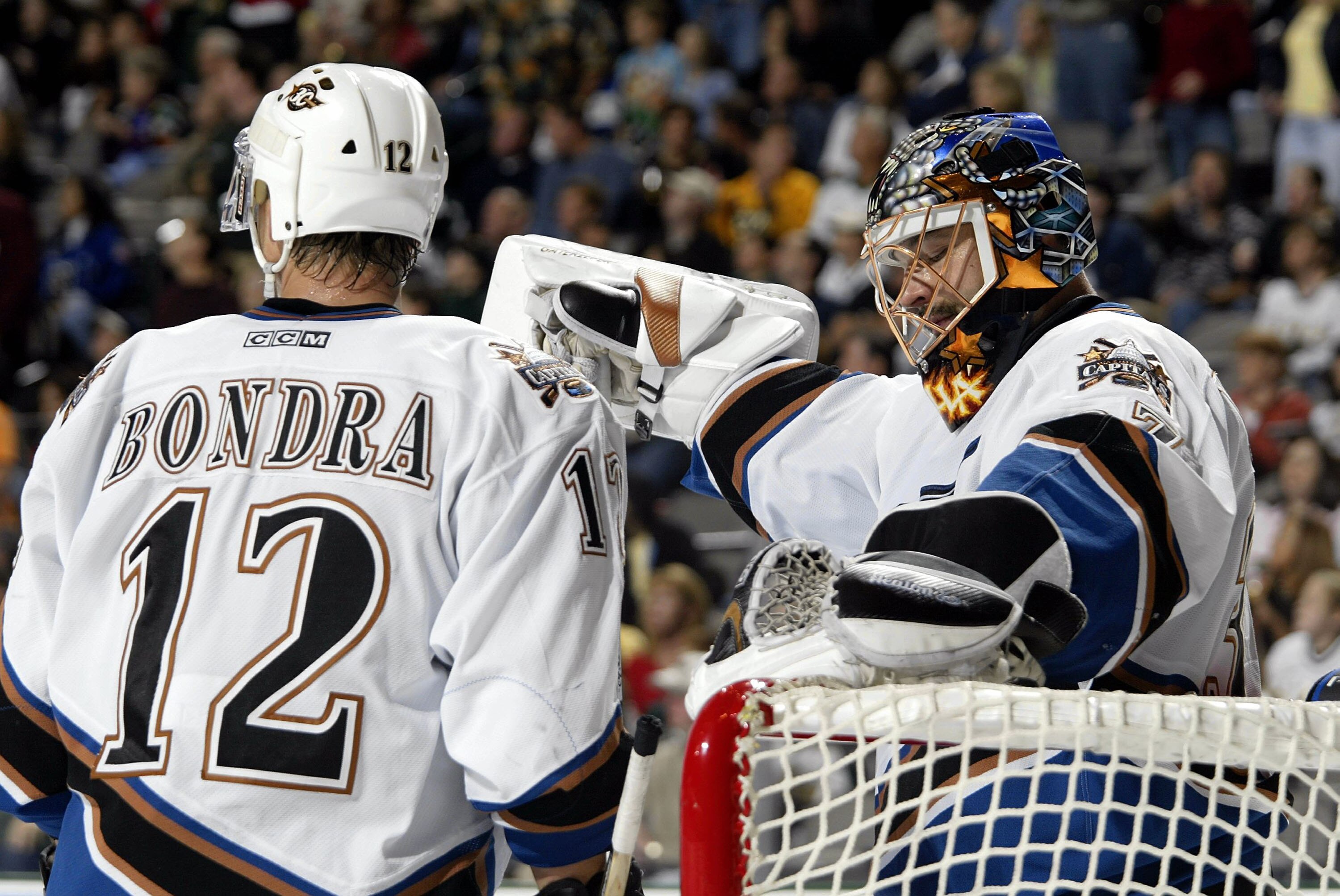 DALLAS - OCTOBER 17:  Goalie Olie Kolzig #37 of the Washington Capitals reacts with Peter Bondra #12 after a goal was awarded to Jason Arnott #44 of the Dallas Stars at the American Airlines Center on October 17, 2003 in Dallas, Texas.  (Photo by Ronald M