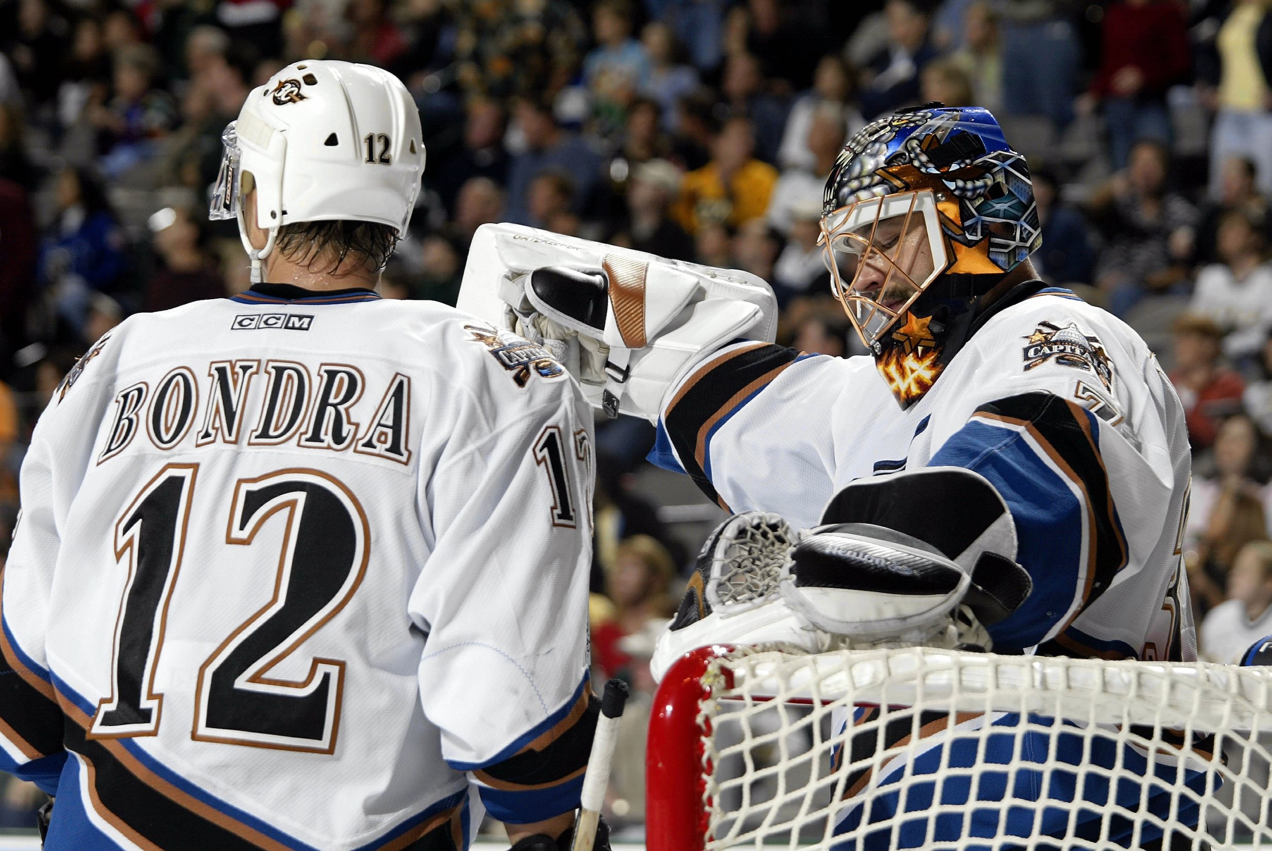 DALLAS - OCTOBER 17:  Goalie Olie Kolzig #37 of the Washington Capitals reacts with Peter Bondra #12 after a goal was awarded to Jason Arnott #44 of the Dallas Stars at the American Airlines Center on October 17, 2003 in Dallas, Texas.  (Photo by Ronald M