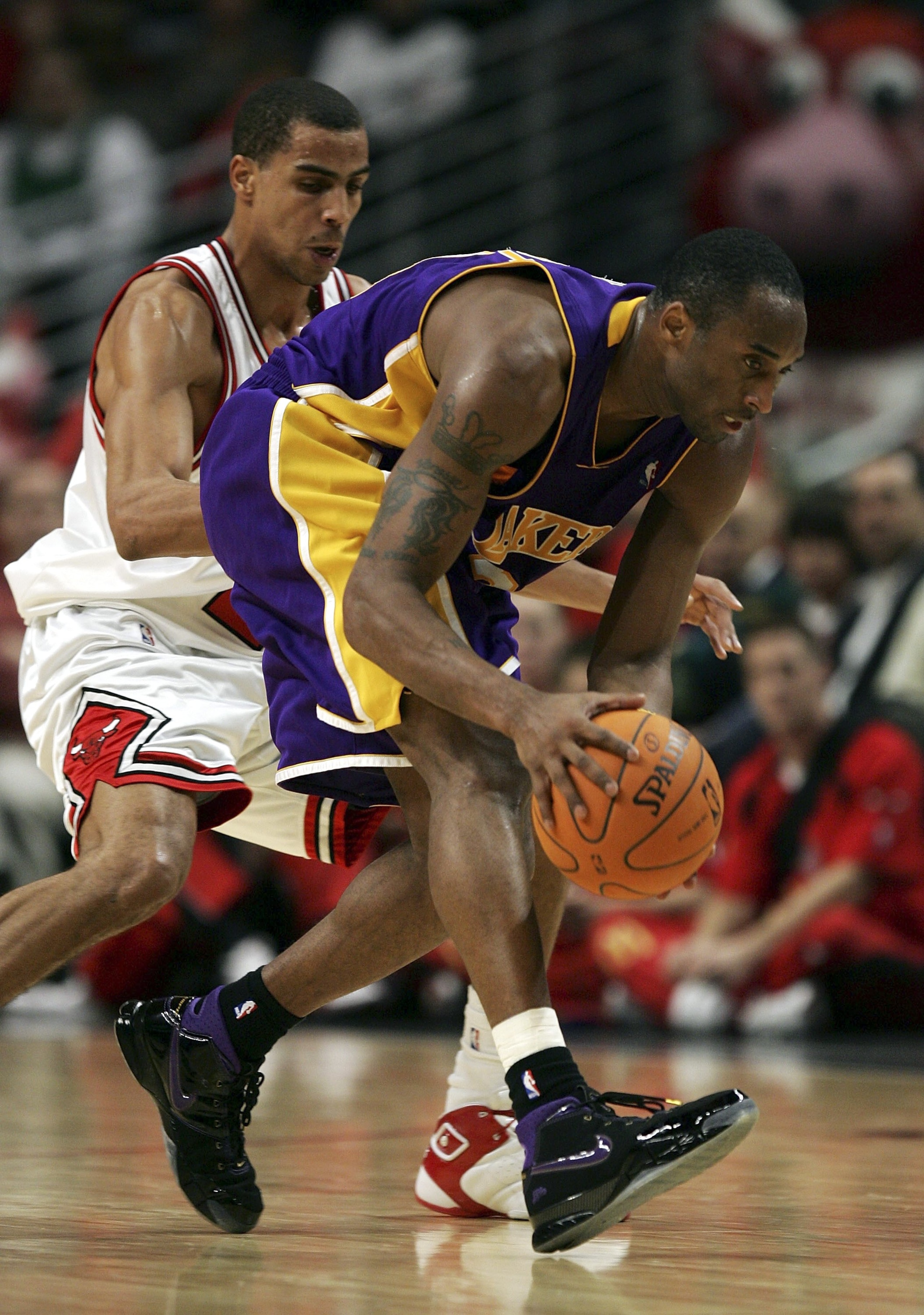 CHICAGO - DECEMBER 19:  Kobe Bryant #24 of the Los Angeles Lakers runs down a loose ball as Thabo Sefolosha #2 of the Chicago Bulls defends on December 19, 2006 at the United Center in Chicago, Illinois. The Bulls defeated the Lakers 94-89. NOTE TO USER: 