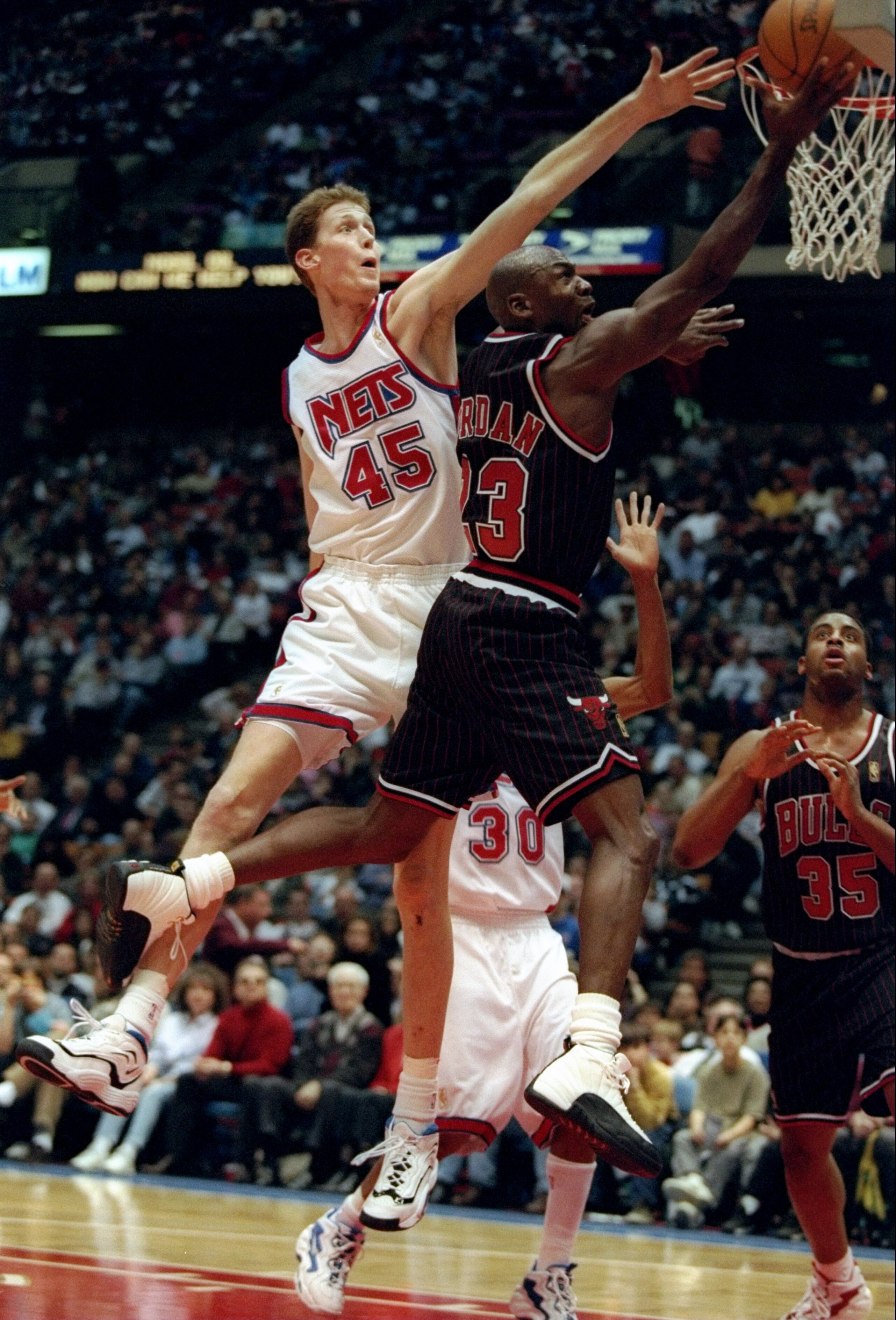 13 Dec 1996:  Guard Michael Jordan of the Chicago Bulls goes up for two as New Jersey Nets center Shawn Bradley covers him during a game at the Continental Airlines Arena in East Rutherford, New Jersey.  The Bulls won the game, 114-92. Mandatory Credit: A