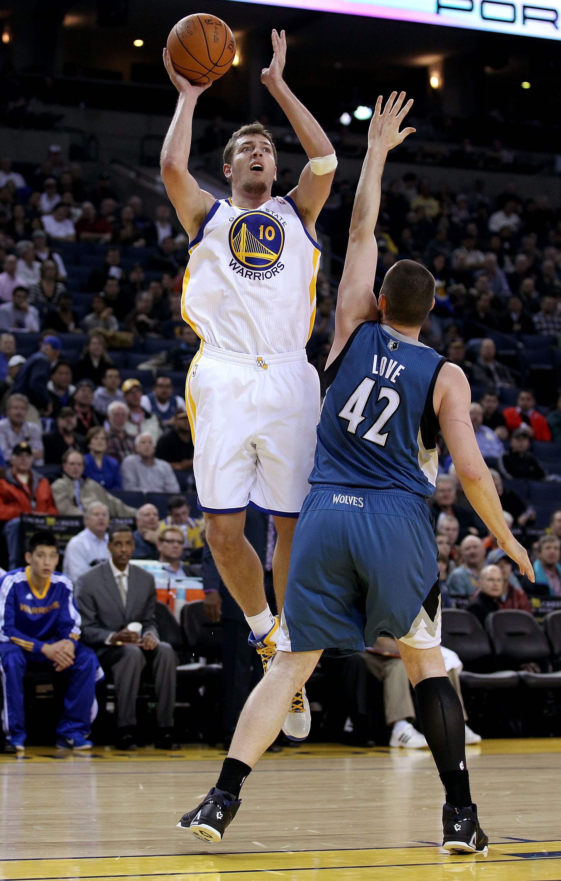 OAKLAND, CA - DECEMBER 14:  David Lee #10 of the Golden State Warriors shoots over Kevin Love #42 of the Minnesota Timberwolves at Oracle Arena on December 14, 2010 in Oakland, California.  NOTE TO USER: User expressly acknowledges and agrees that, by dow