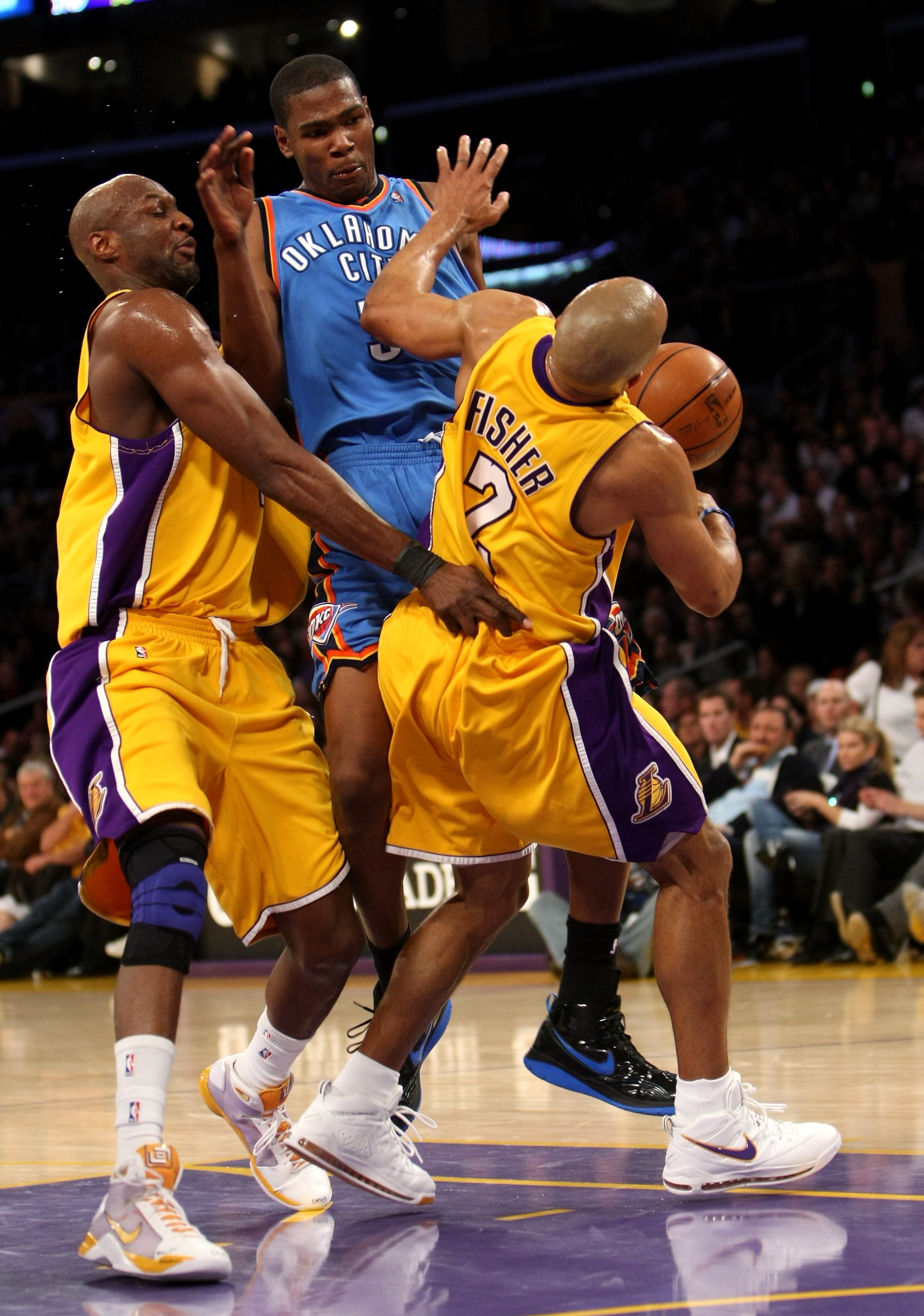 LOS ANGELES, CA - FEBRUARY 10:  Kevin Durant #35 of the Oklahoma City Thunder picks up a charging foul as he runs into Derek Fisher #2 and Lamar Odom #7 of the Los Angeles Lakers on February 10, 2009 at Staples Center in Los Angeles, California.  The Lake