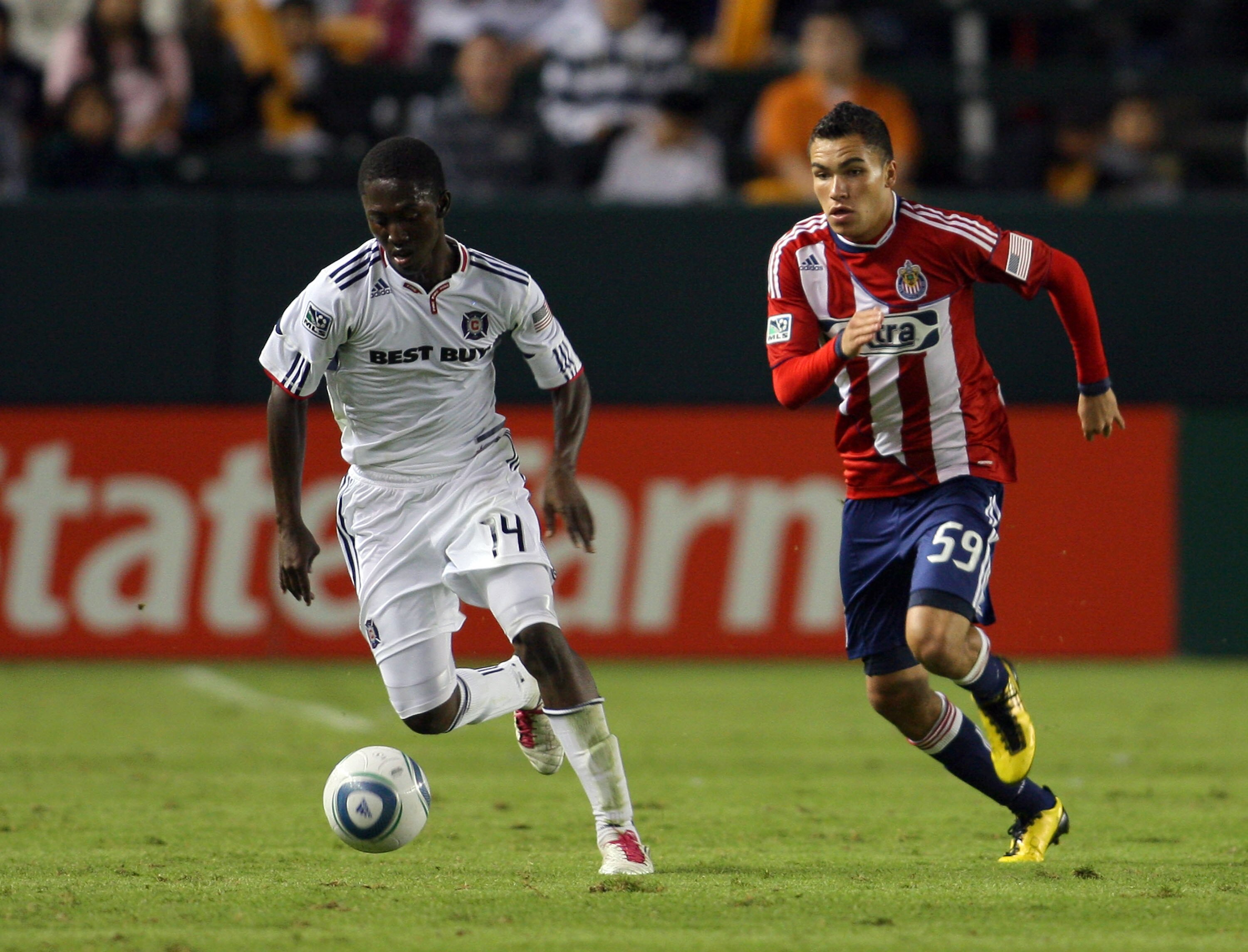 CARSON, CA - OCTOBER 23:  Patrick Nyarko #14 of the Chicago Fire dribbles the ball on the counterattack under pressure from Bryan de la Fuente #59 of Chivas USA in the second half of their MLS match on October 23, 2010 in Carson, California. The Fire defe