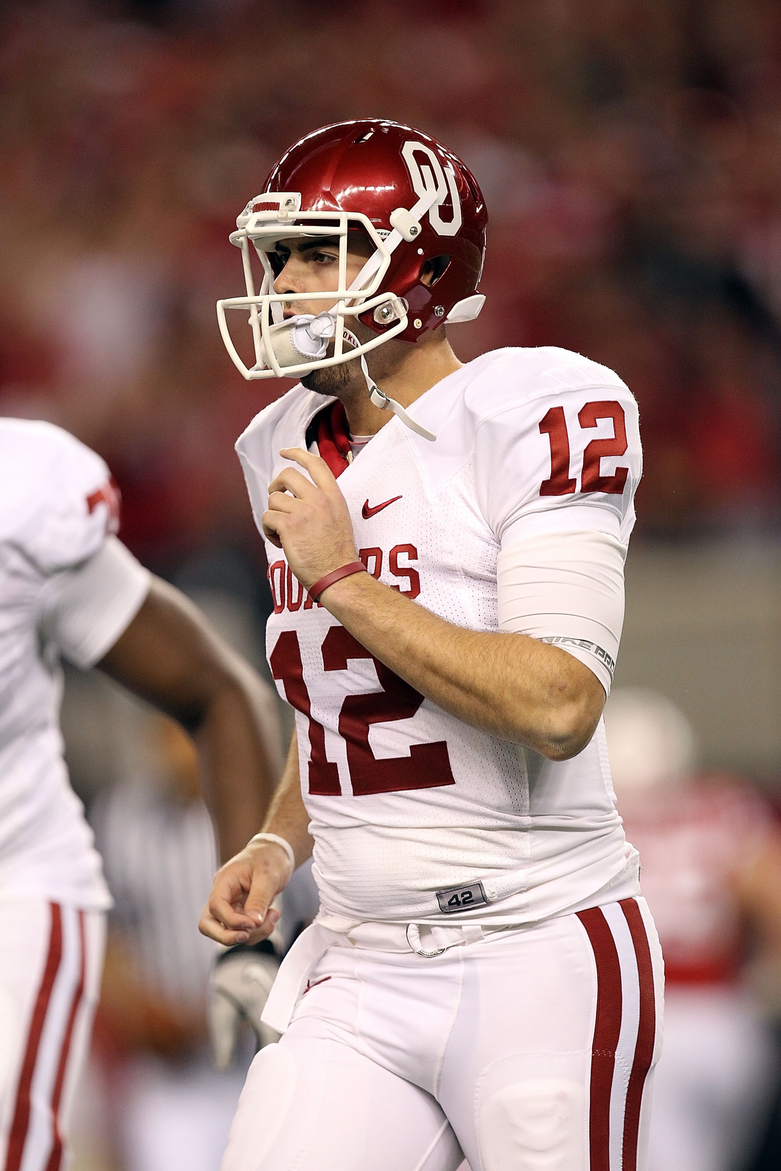 ARLINGTON, TX - DECEMBER 04:  Quarterback Landry Jones #12 of the Oklahoma Sooners drops back to pass against the Nebraska Cornhuskers during the Big 12 Championship at Cowboys Stadium on December 4, 2010 in Arlington, Texas.  (Photo by Ronald Martinez/Ge