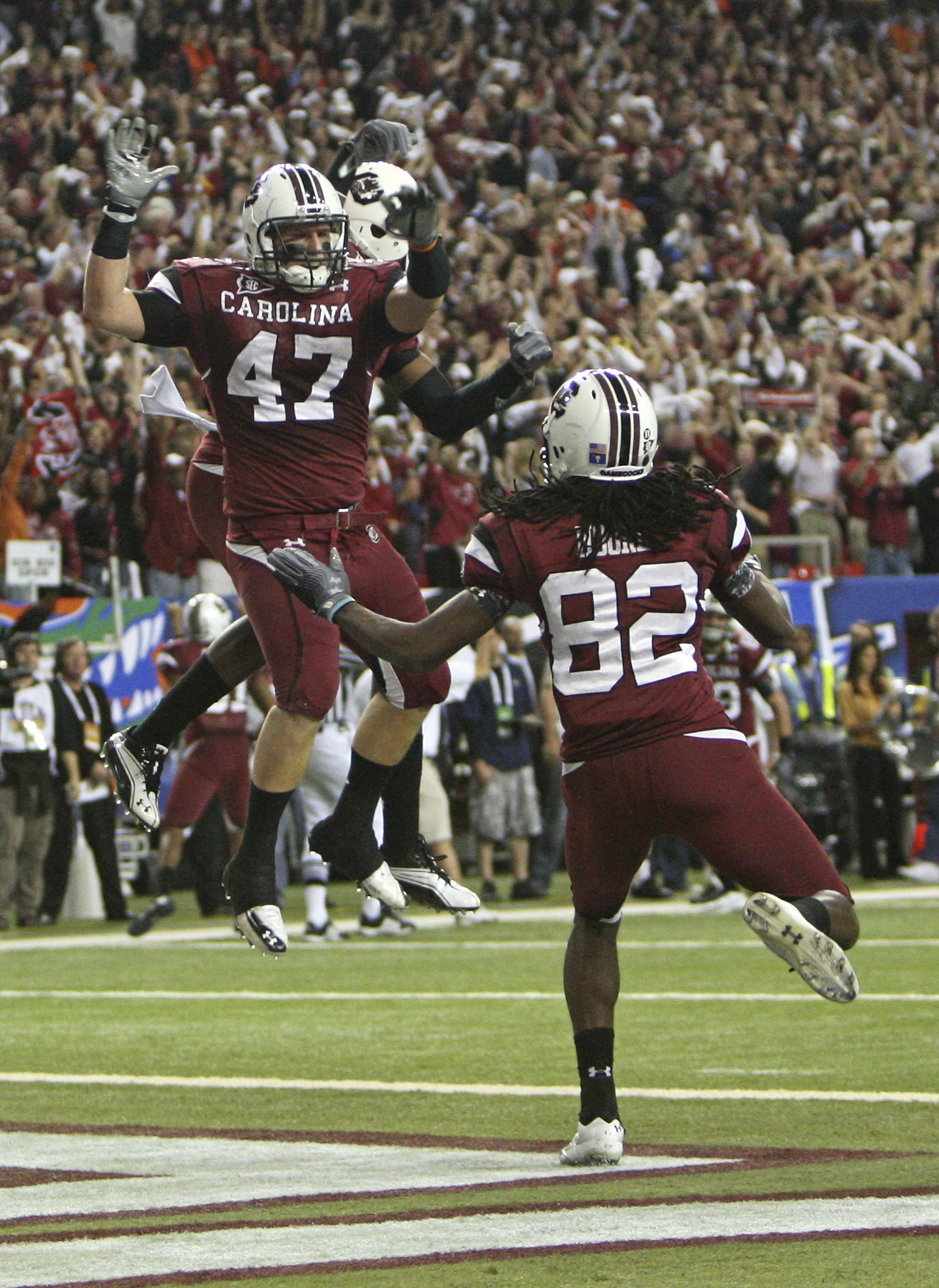 ATLANTA - DECEMBER 4:  Fullback Patrick DiMarco #47 of the South Carolina Gamecocks celebrates a touchdown while teammate and wide receiver D.L. Moore #82 joins him during the 2010 SEC Championship against the Auburn Tigers at Georgia Dome on December 4,
