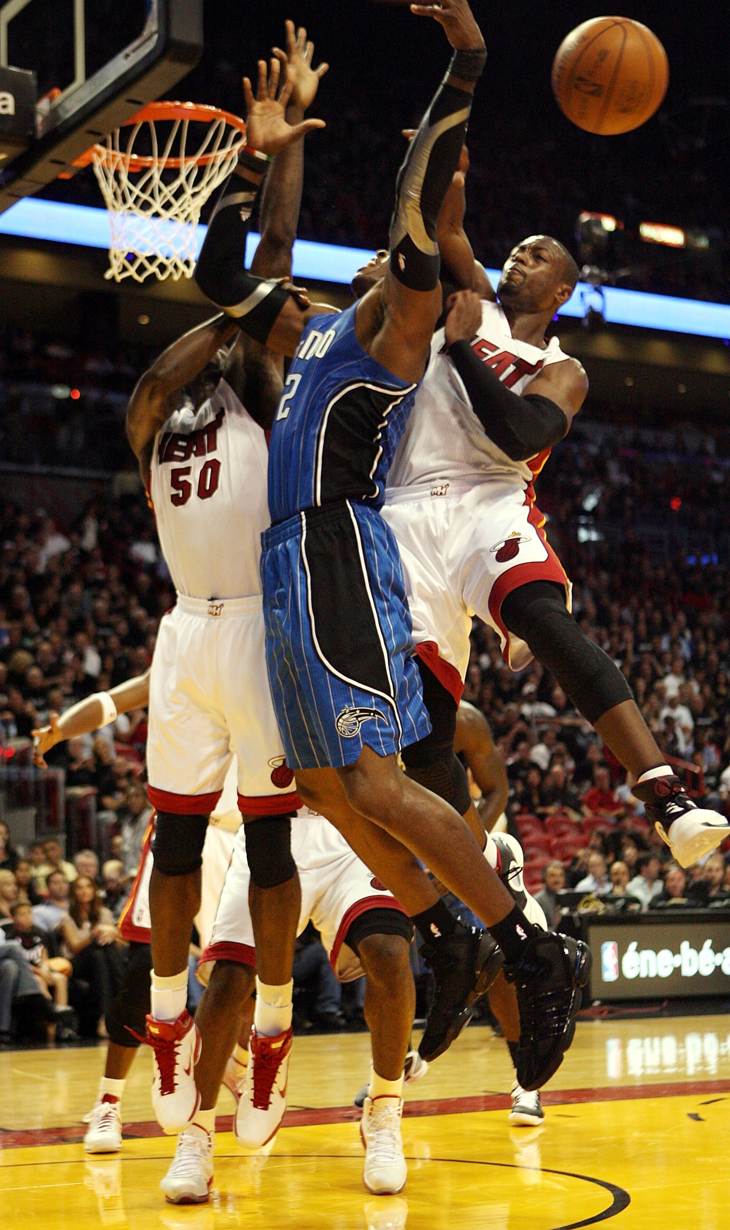 MIAMI - OCTOBER 29:  Guard Dwyane Wade #3 of the Miami Heat blocks a shot against Dwight Howard #12  of the Orlando Magic at American Airlines Arena on October 29, 2010 in Miami, Florida. NOTE TO USER: User expressly acknowledges and agrees that, by downl