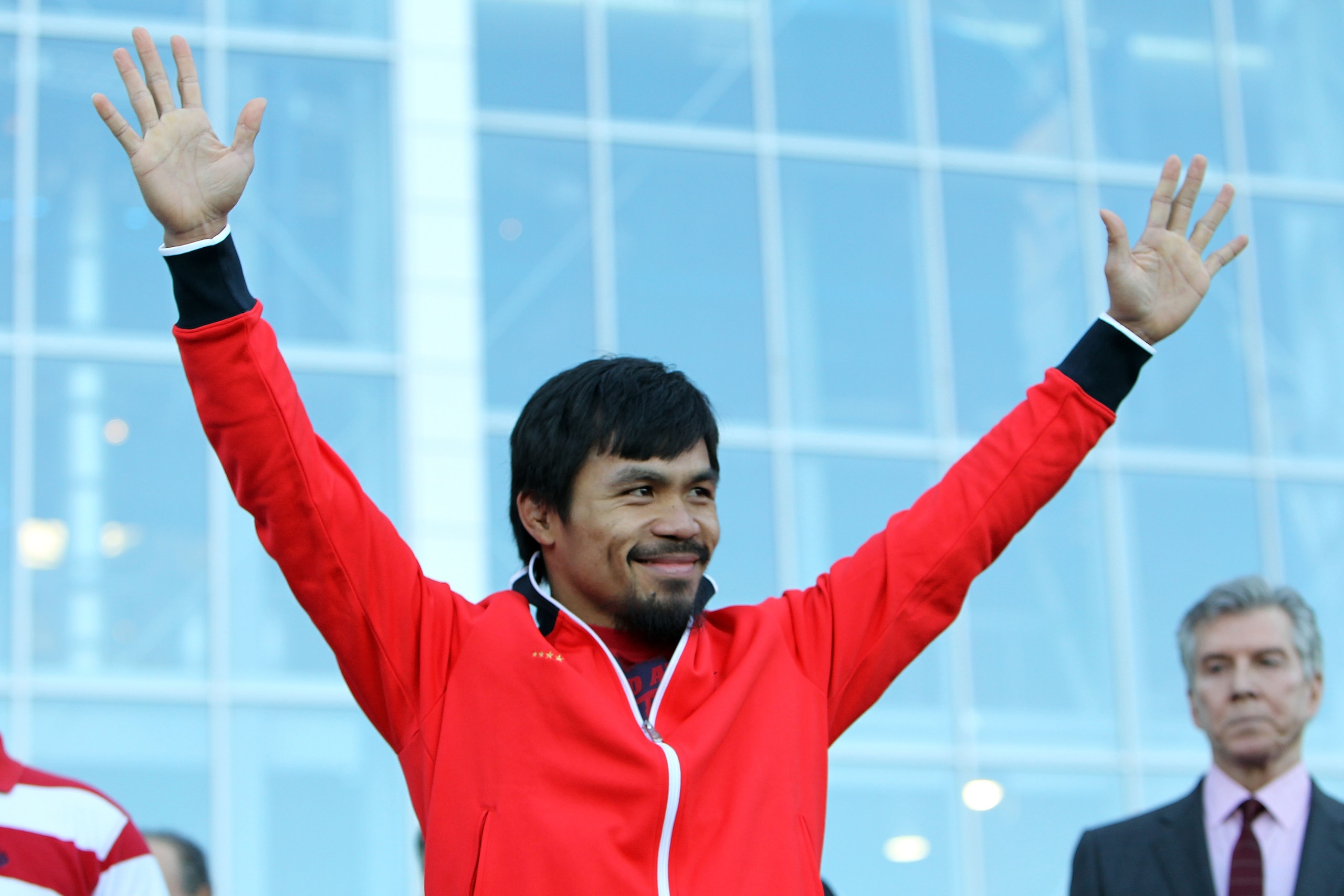 ARLINGTON, TX - MARCH 12:  Manny Pacquiao of the Philippines waves to the crowd during the weigh-in for his WBO welterweight title fight against Joshua Clottey of Ghana outside Cowboys Stadium on March 12, 2010 in Arlington, Texas. Pacquiao and Clottey wi