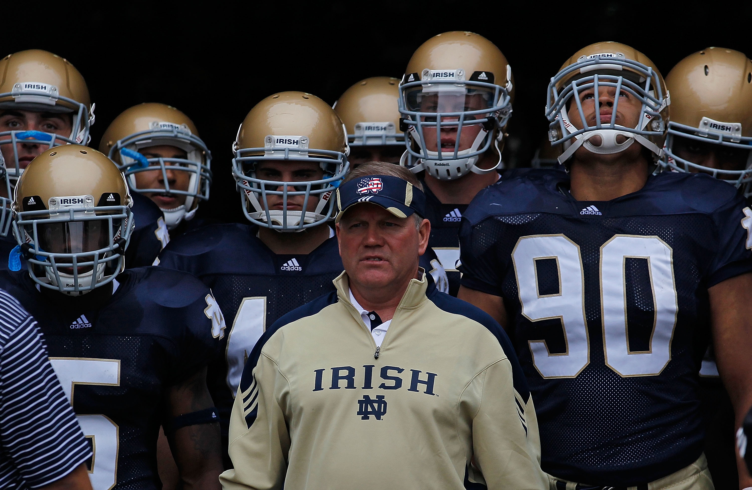 SOUTH BEND, IN - SEPTEMBER 11: Head coach Brian Kelly of the Notre Dame Fighting Irish waits to enter the field with his team including Armando Allen, Jr. #5, Carlo Calabrese #44 and Ethan Johnson #90 before a game against the Michigan Wolverines at Notre