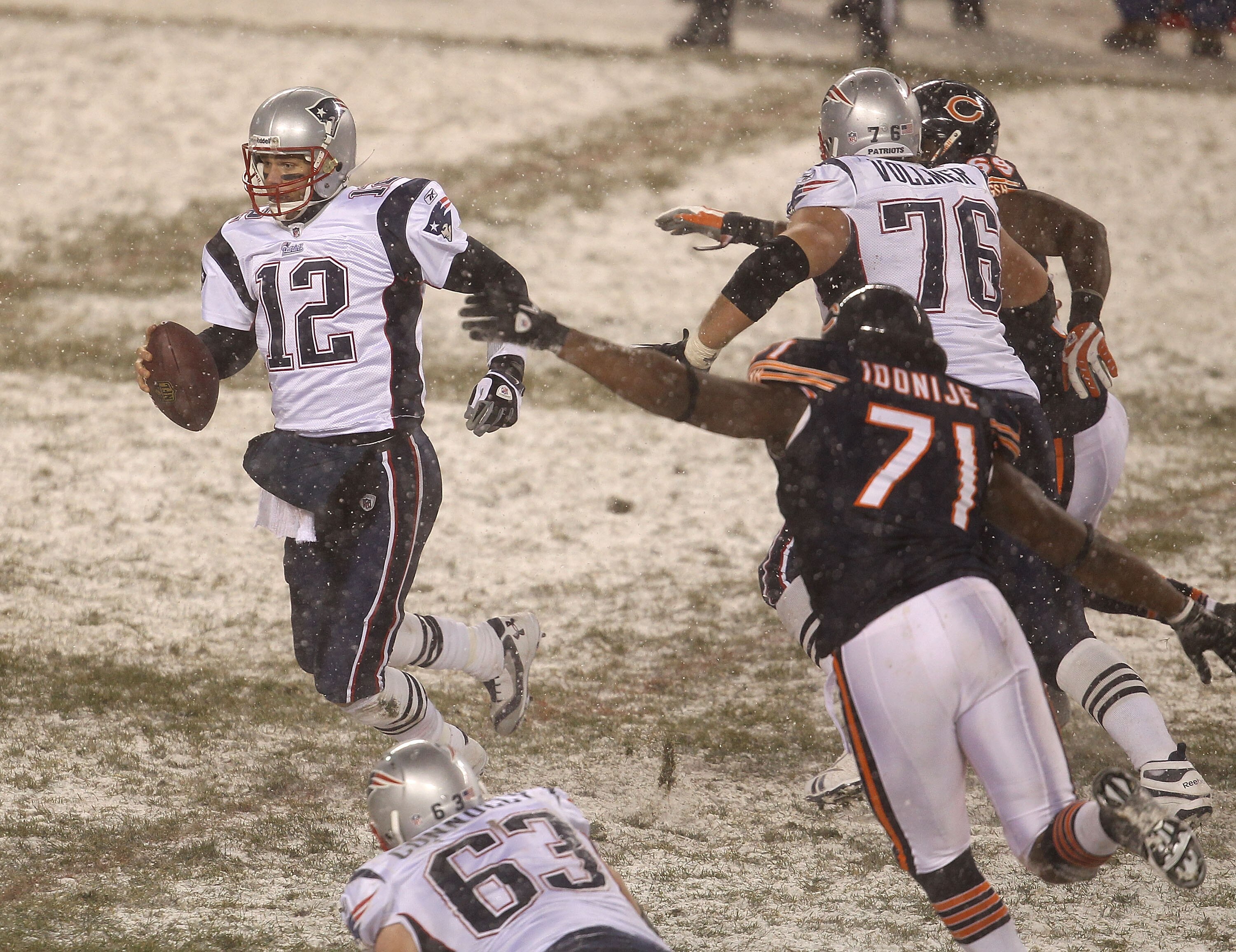 CHICAGO - DECEMBER 12: Tom Brady #12 of the New England Patriots moves to avoid Israel Idonije #71 of the Chicago Bears as he looks for a receiver at Soldier Field on December 12, 2010 in Chicago, Illinois. The Patriots defeated the Bears 36-7. (Photo by 