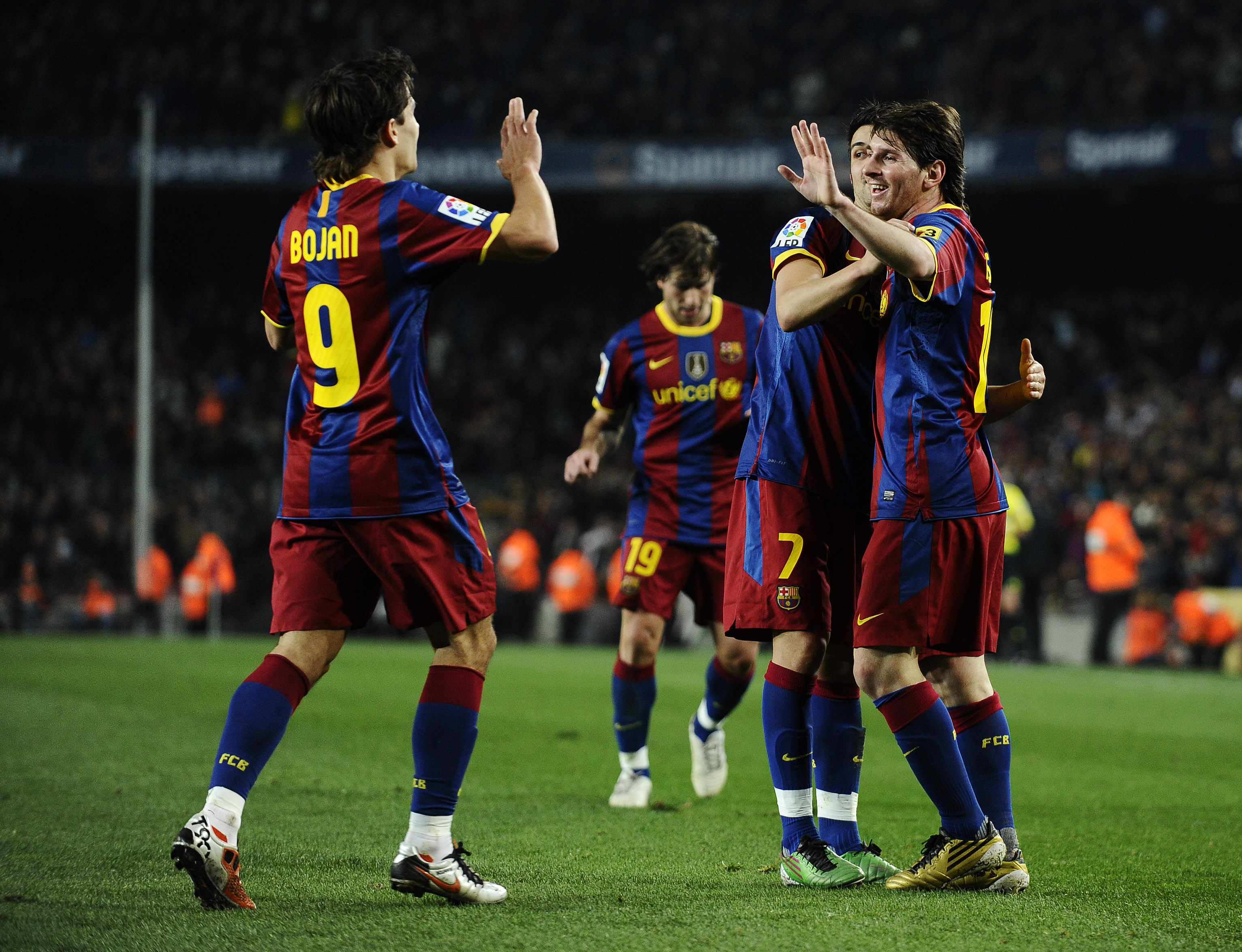 BARCELONA, SPAIN - DECEMBER 12:  Lionel Messi of Barcelona (R), David Villa (2ndR) and Bojan Krkic celebrate after Lionel Messi scored his second goal during the La Liga match between Barcelona and Real Sociedad at Camp Nou Stadium on December 12, 2010 in
