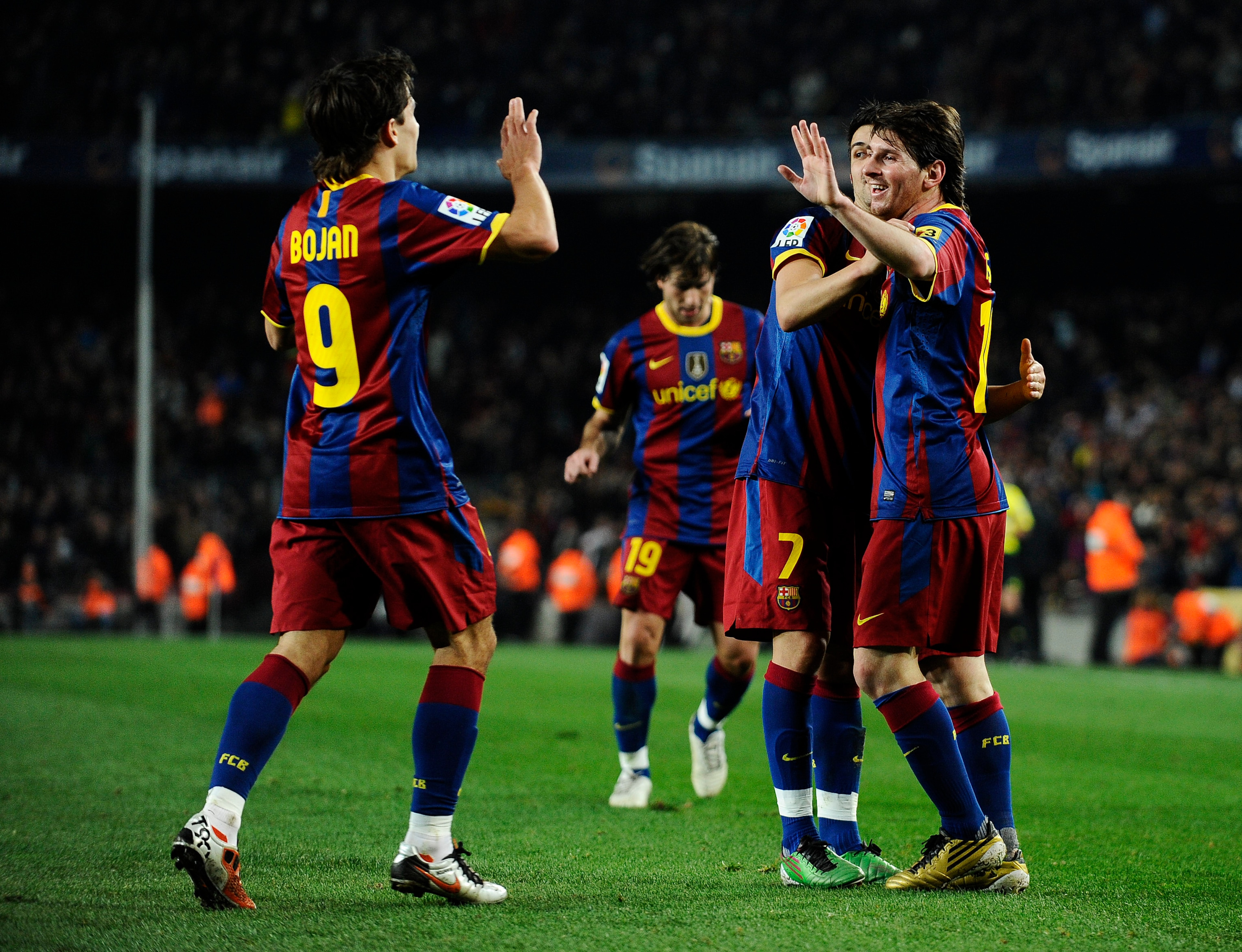 BARCELONA, SPAIN - DECEMBER 12:  Lionel Messi of Barcelona (R), David Villa (2ndR) and Bojan Krkic celebrate after Lionel Messi scored his second goal during the La Liga match between Barcelona and Real Sociedad at Camp Nou Stadium on December 12, 2010 in