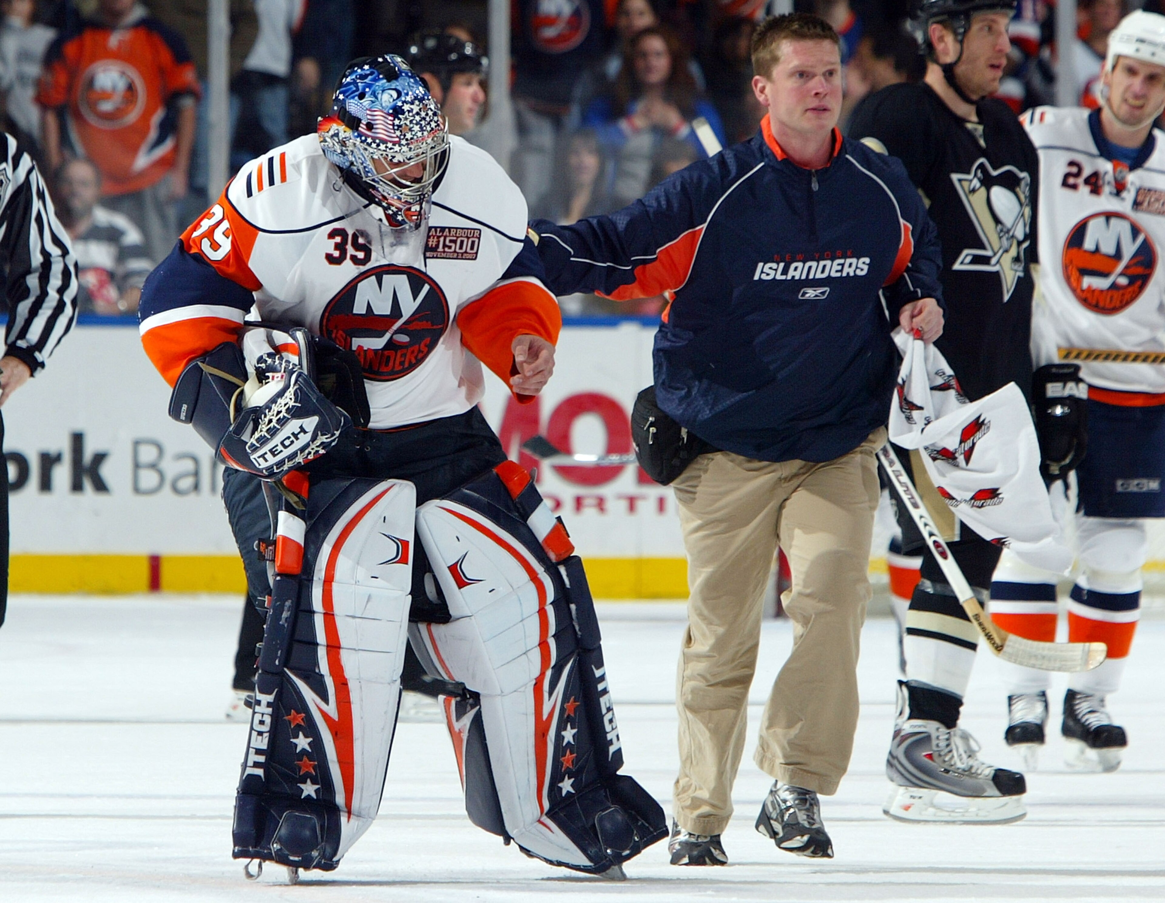 UNIONDALE, NY - NOVEMBER 03: Goaltender Rick DiPietro #39 of the New York Islanders is led off the ice by trainer Garrett Timms after suffering an eye injury against the Pittsburgh Penguins during their game on November 3, 2007 at Nassau Coliseum in Union UNIONDALE, NY - NOVEMBER 03: Goaltender Rick DiPietro #39 of the New York Islanders is led off the ice by trainer Garrett Timms after suffering an eye injury against the Pittsburgh Penguins during their game on November 3, 2007 at Nassau Coliseum in Union