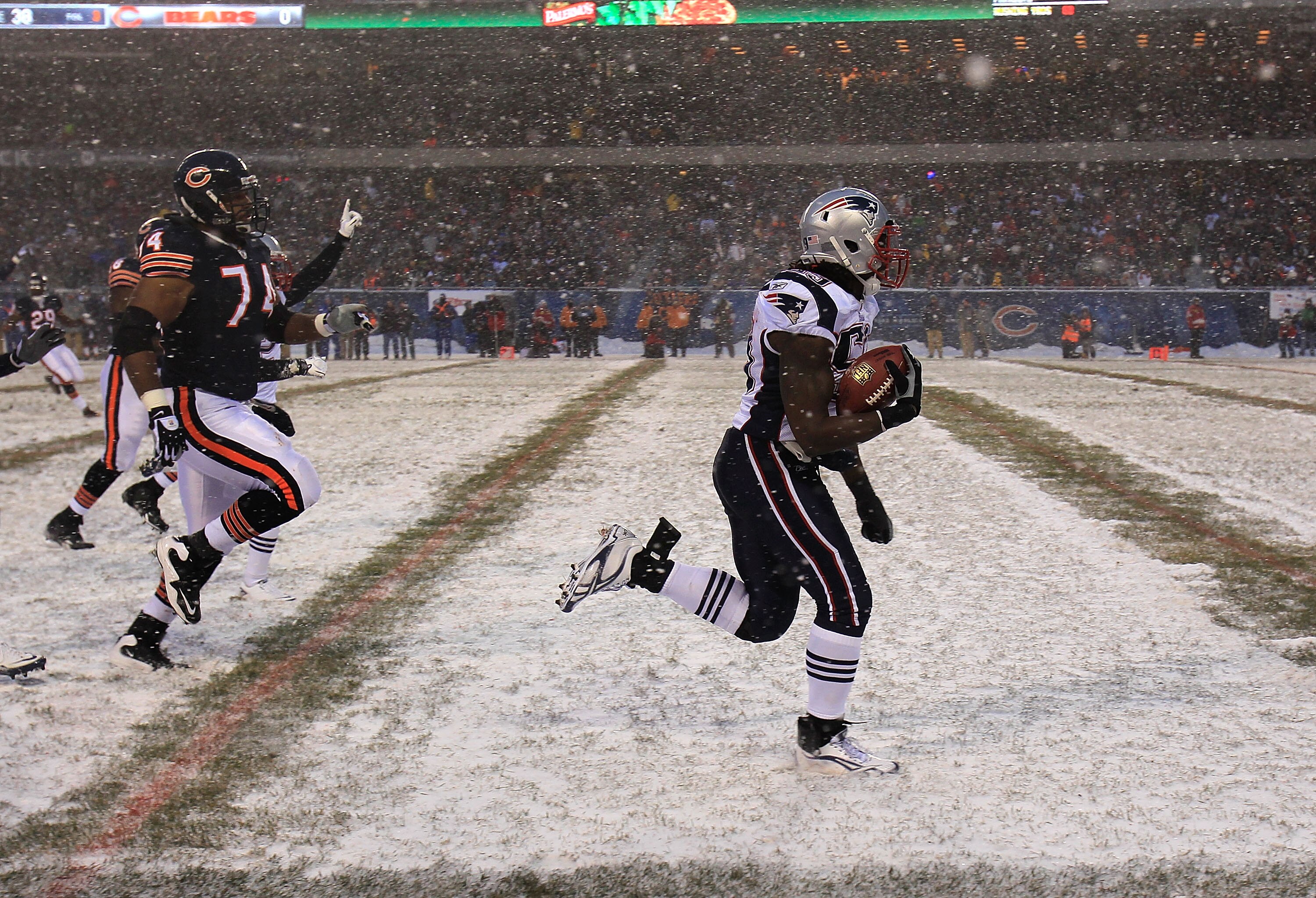 CHICAGO, IL - DECEMBER 12: Gary Guyton #59 of the New England Patriots runs for a touchdown after picking up a fumble as Chris Williams #74 of the Chicago Bears pursues at Soldier Field on December 12, 2010 in Chicago, Illinois. The Patriots defeated the