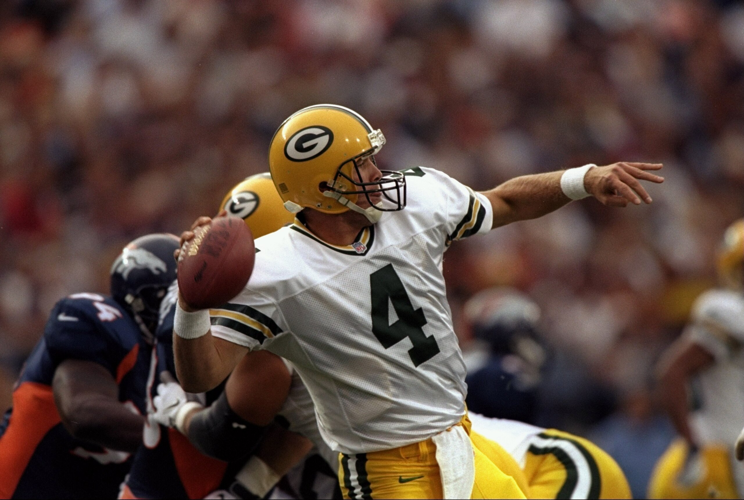 24 Aug 1998:  Quarterback Brett Favre #4 of the Green Bay Packers in action during the pre-season game against the Denver Broncos at the Mile High Stadium in Denver, Colorado. The Broncos defeated the Packers 34-31. Mandatory Credit: Brian Bahr  /Allsport