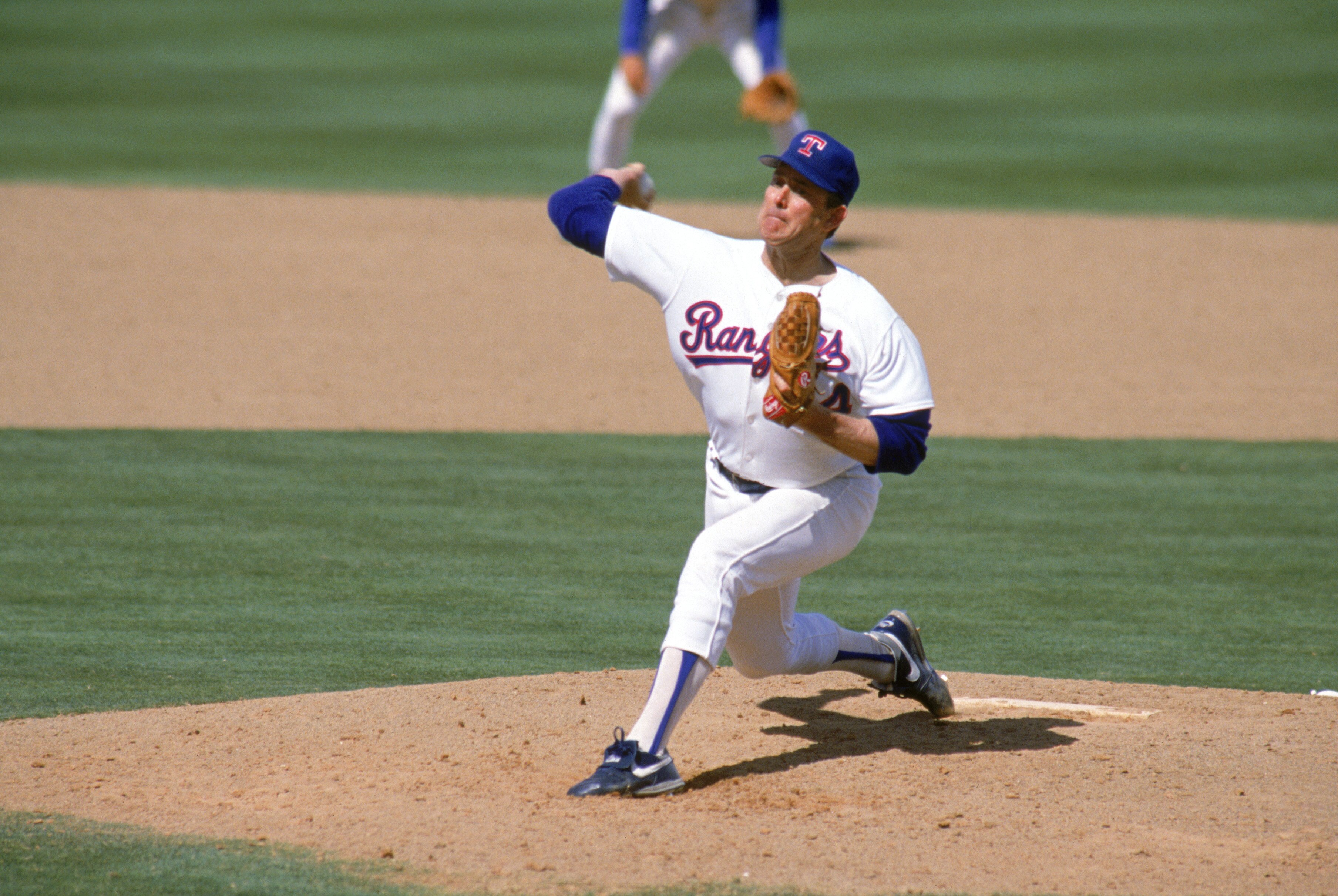 ARLINGTON, TX - 1990:  Nolan Ryan #34 of the Texas Rangers pitches during the 1990 season at Arlington Stadium in Arlington, Texas.  (Photo by Rick Stewart/Getty Images)
