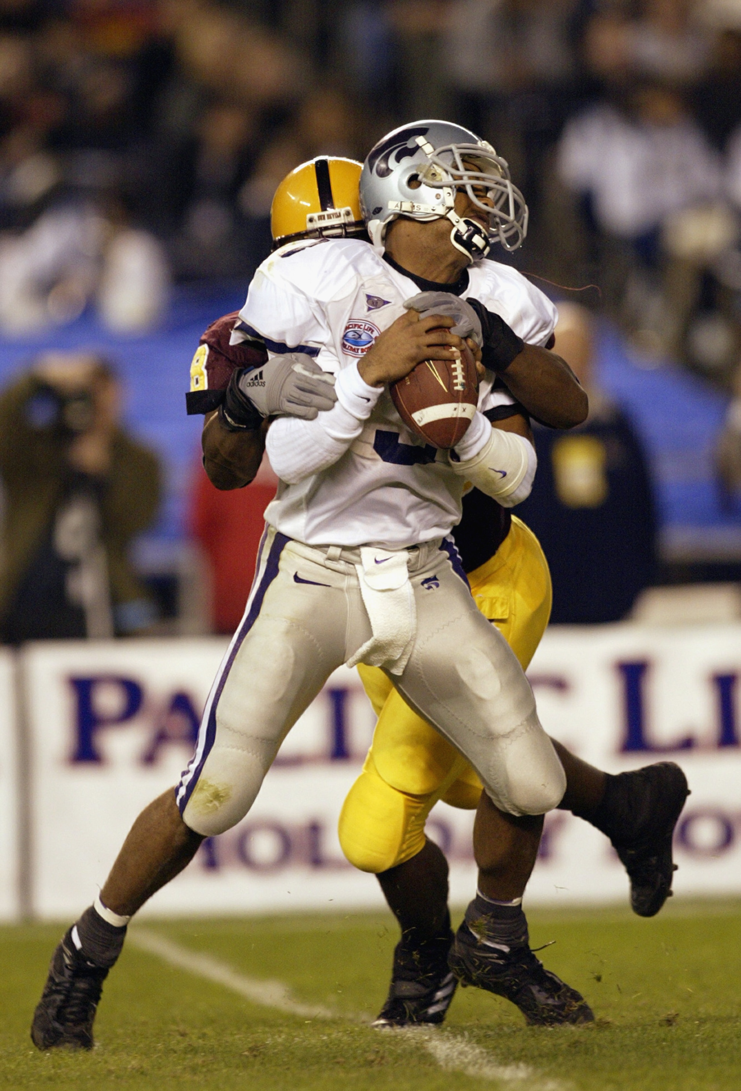 SAN DIEGO - DECEMBER 27:  Quarterback Ell Roberson #3 of the Kansas State Wildcats gets sacked by Terrell Suggs #48 of the Arizona Sun Devils during the first quarter of the Pacific Life Holiday Bowl at Qualcomm Stadium on December 27, 2002 in San Diego,