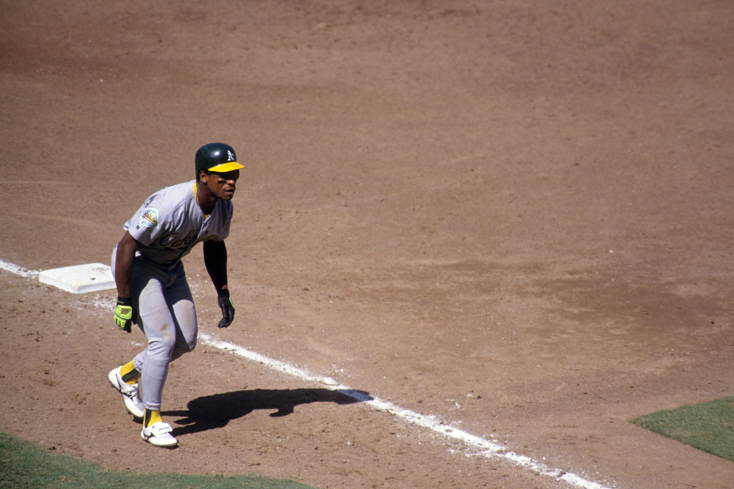 ANAHEIM, CA - SEPTEMBER 6:  Rickey Henderson #24 of the Oakland Athletics leads off from third base during their MLB game against the California Angels at Anaheim Stadium on September 6, 1992 in Anaheim, California. (Photo by Ken Levine/Getty Images)