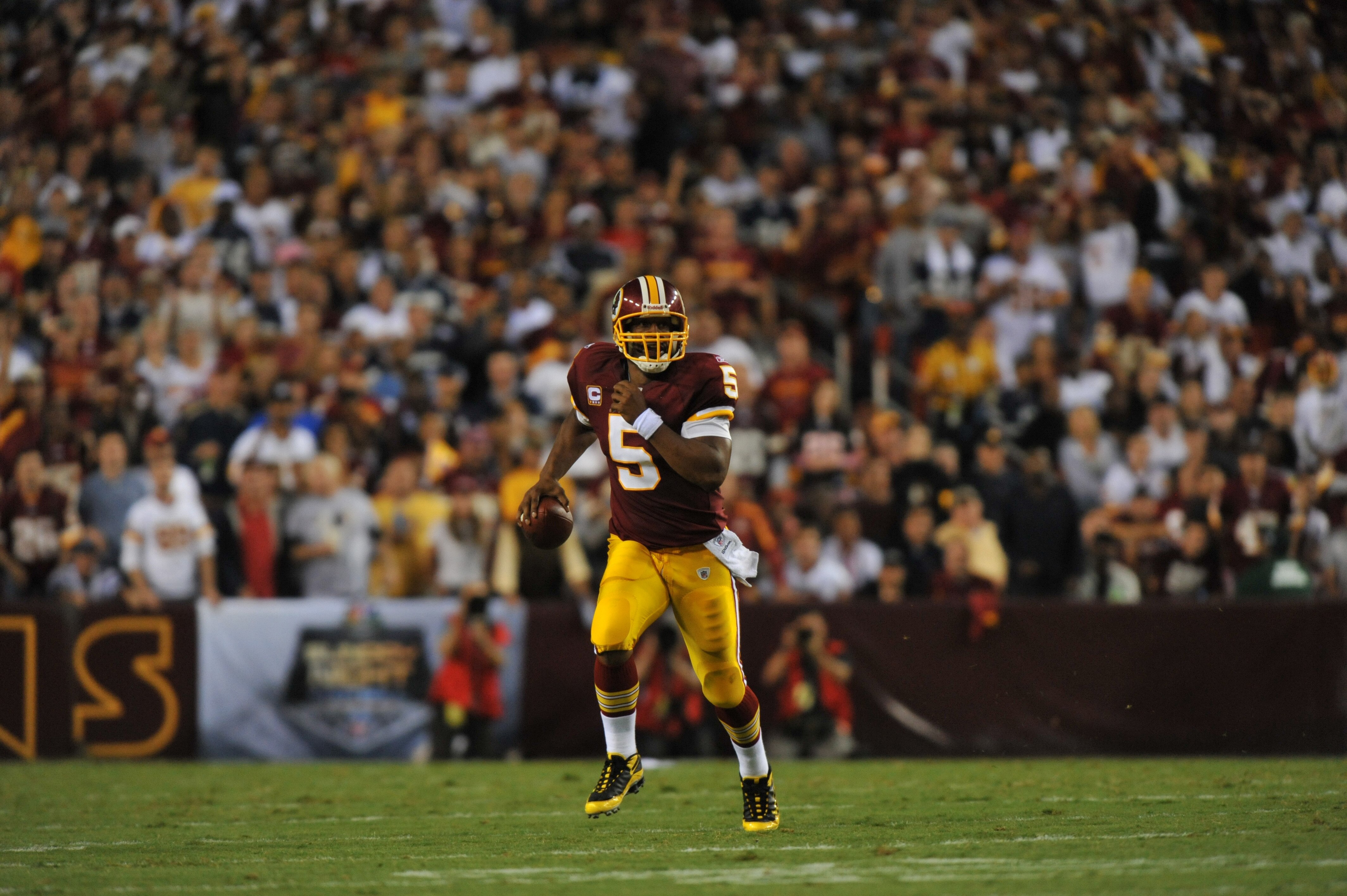 LANDOVER - SEPTEMBER 12:  Donovan McNabb #5 of the Washington Redskins runs the ball during the NFL season opener against the Dallas Cowboys at FedExField on September 12, 2010 in Landover, Maryland. The Redskins defeated the Cowboys 13-7. (Photo by Larry
