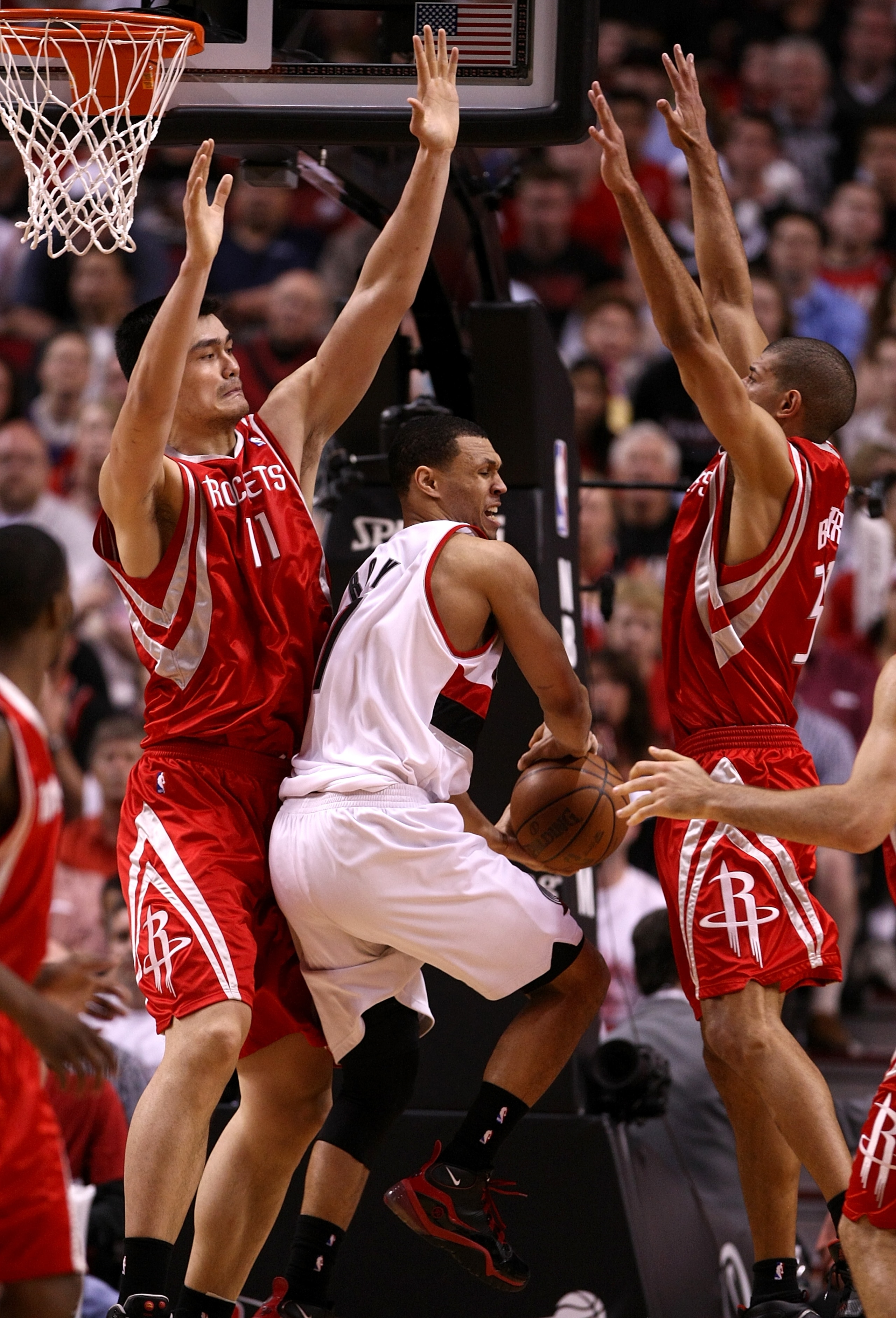 PORTLAND, OR - APRIL 21:  Brandon Roy #7 of the Portland Trail Blazers drives against Yao Ming #11 and Shane Battier #31 of the Houston Rockets during Game 2 of the Western Conference Quarterfinals of the NBA Playoffs on April 21, 2009 at the Rose Garden