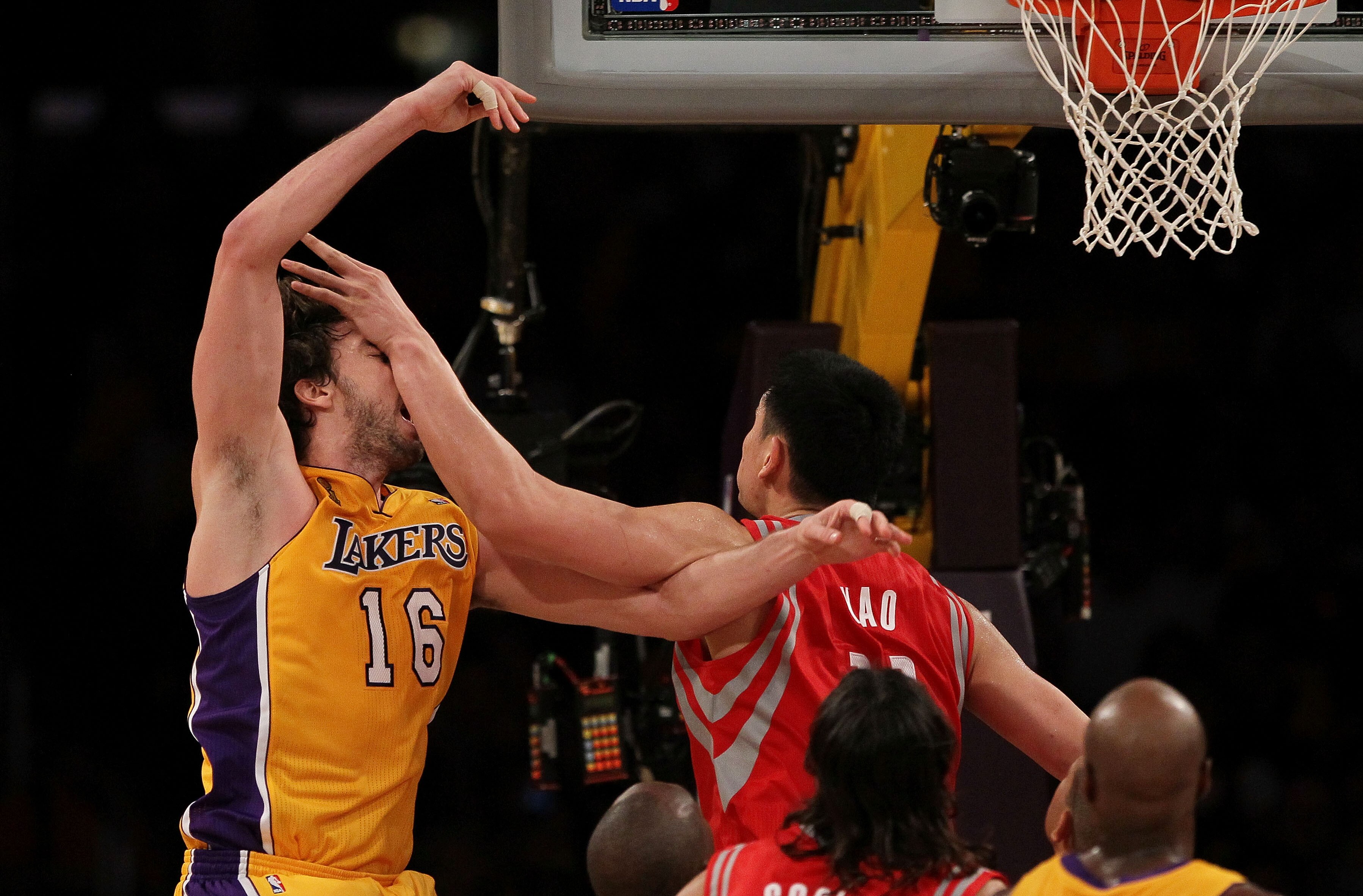 LOS ANGELES, CA - OCTOBER 26:  Pau Gasol #16 of the Los Angeles Lakers is hit by Yao Ming #11 of the Houston Rockets during their NBA game at Staples Center on October 26, 2010 in Los Angeles, California. NOTE TO USER: User expressly acknowledges and agre