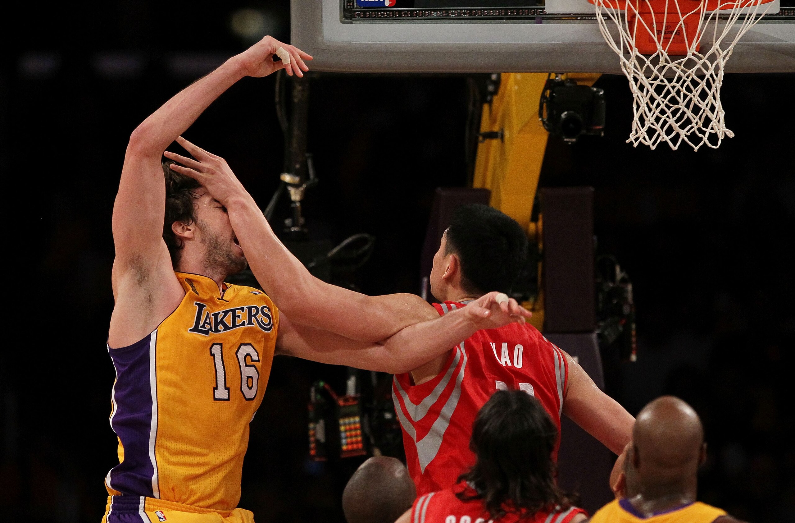 LOS ANGELES, CA - OCTOBER 26:  Pau Gasol #16 of the Los Angeles Lakers is hit by Yao Ming #11 of the Houston Rockets during their NBA game at Staples Center on October 26, 2010 in Los Angeles, California. NOTE TO USER: User expressly acknowledges and agre