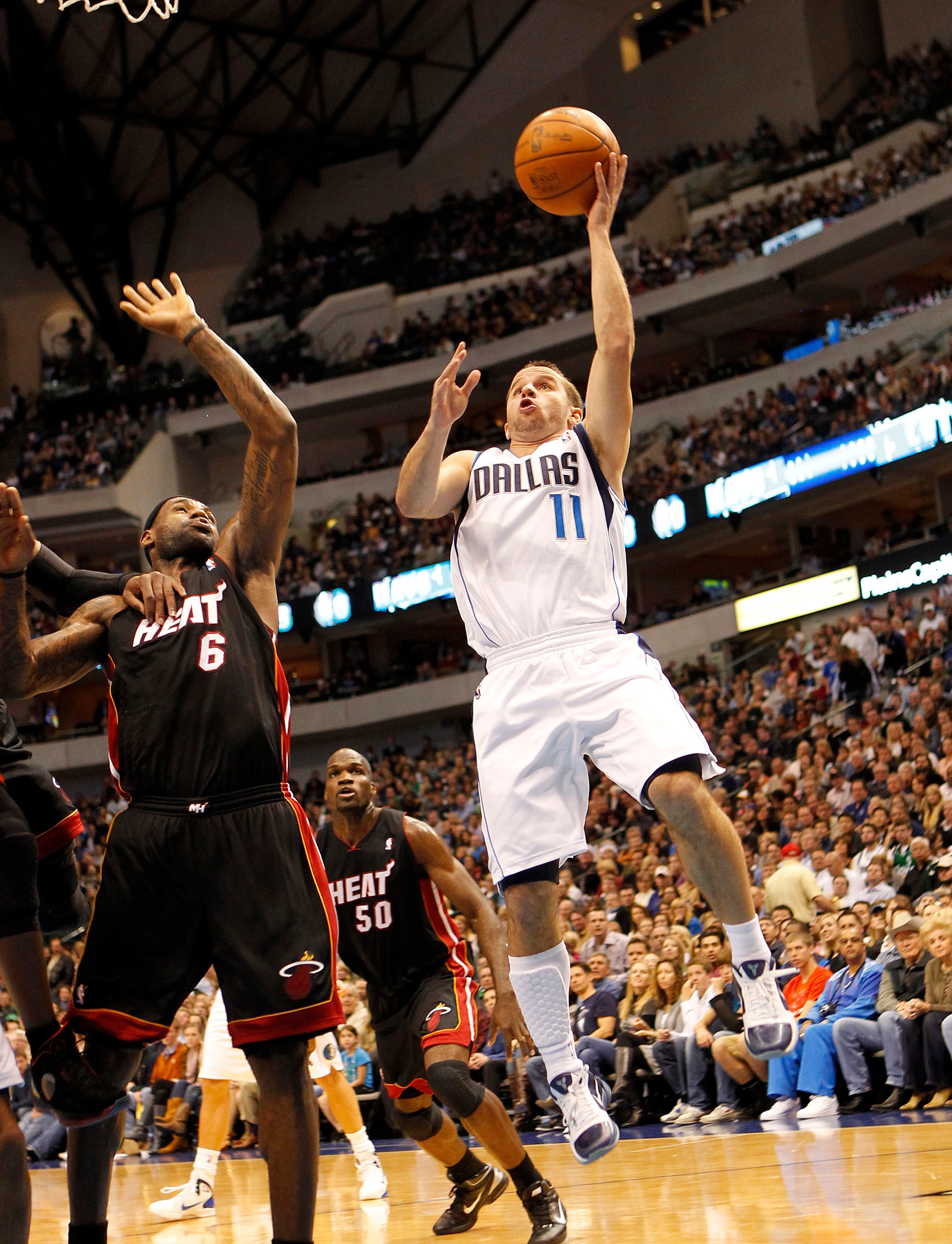 DALLAS - NOVEMBER 27: Jose Barea #11 of the Dallas Mavericks shoots over Lebron James #6 of the Miami Heat on November 27, 2010 at the American Airlines Center in Dallas, Texas. NOTE TO USER: User expressly acknowledges and agrees that, by downloading and
