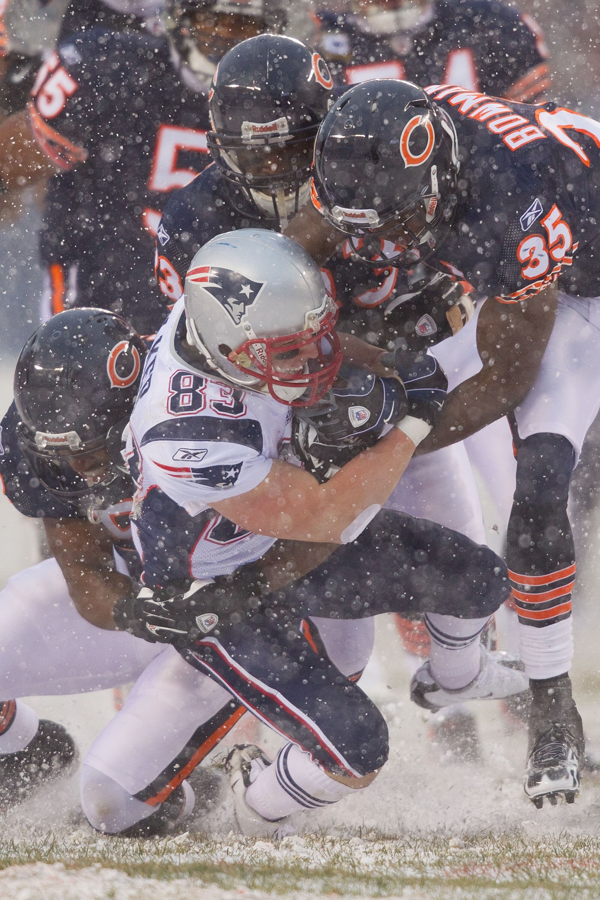 CHICAGO, IL - DECEMBER 12: Wes Welker #83 of the New England Patriots is tackled by Zack Bowman #35 of the Chicago Bears at Soldier Field on December 12, 2010 in Chicago, Illinois.  The Patriots beat the Bears 36-7.  (Photo by Dilip Vishwanat/Getty Images