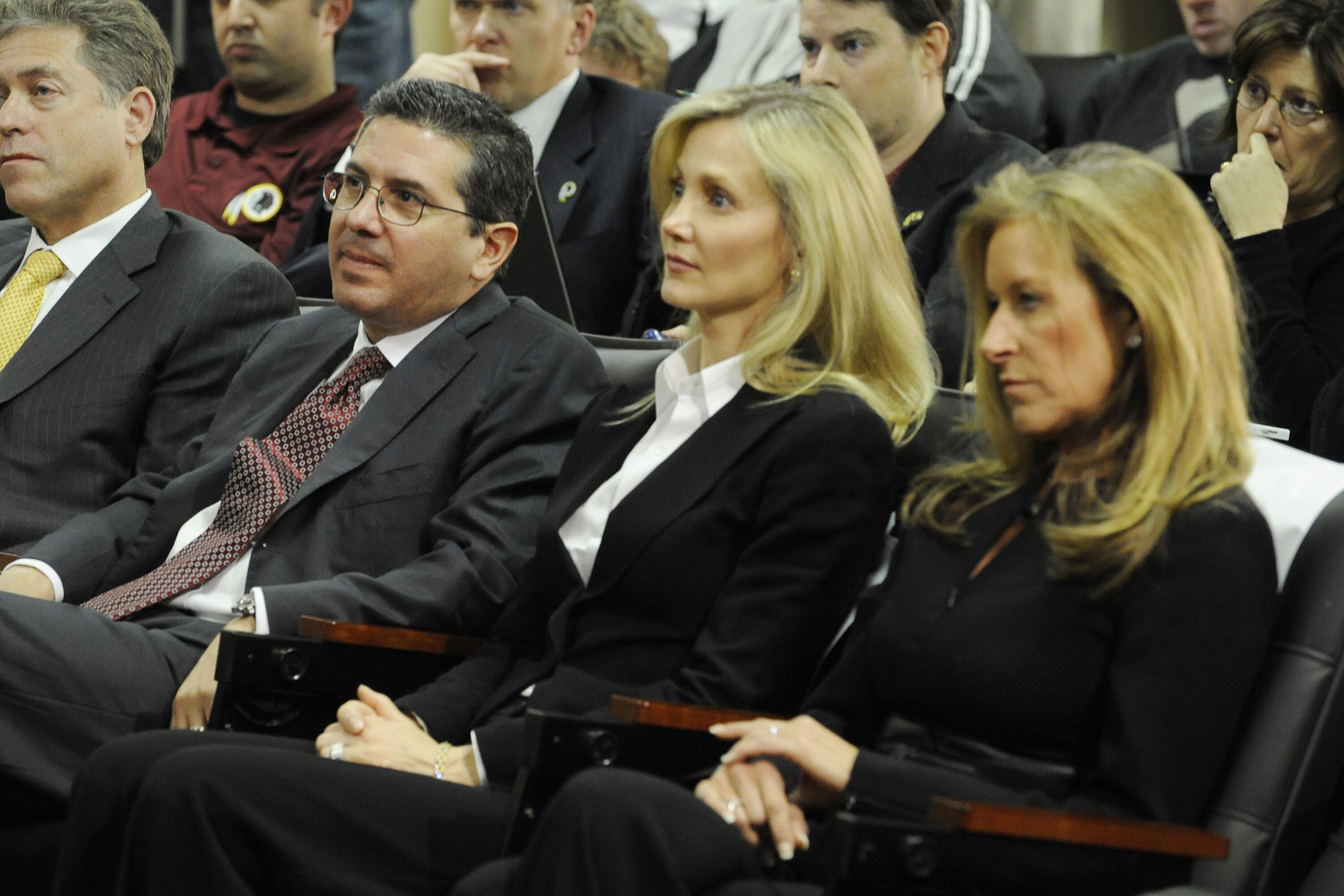 ASHBURN,VA - JANUARY 6:  Dan Snyder (L), owner of the Washington Redskins with wife Tanya (C) and Peggy Shanahan (R) look on as Mike Shanahan is introduced to the media on January 6, 2010 at Redskins Park in Ashburn, Virginia.  (Photo by Mitchell Layton/G