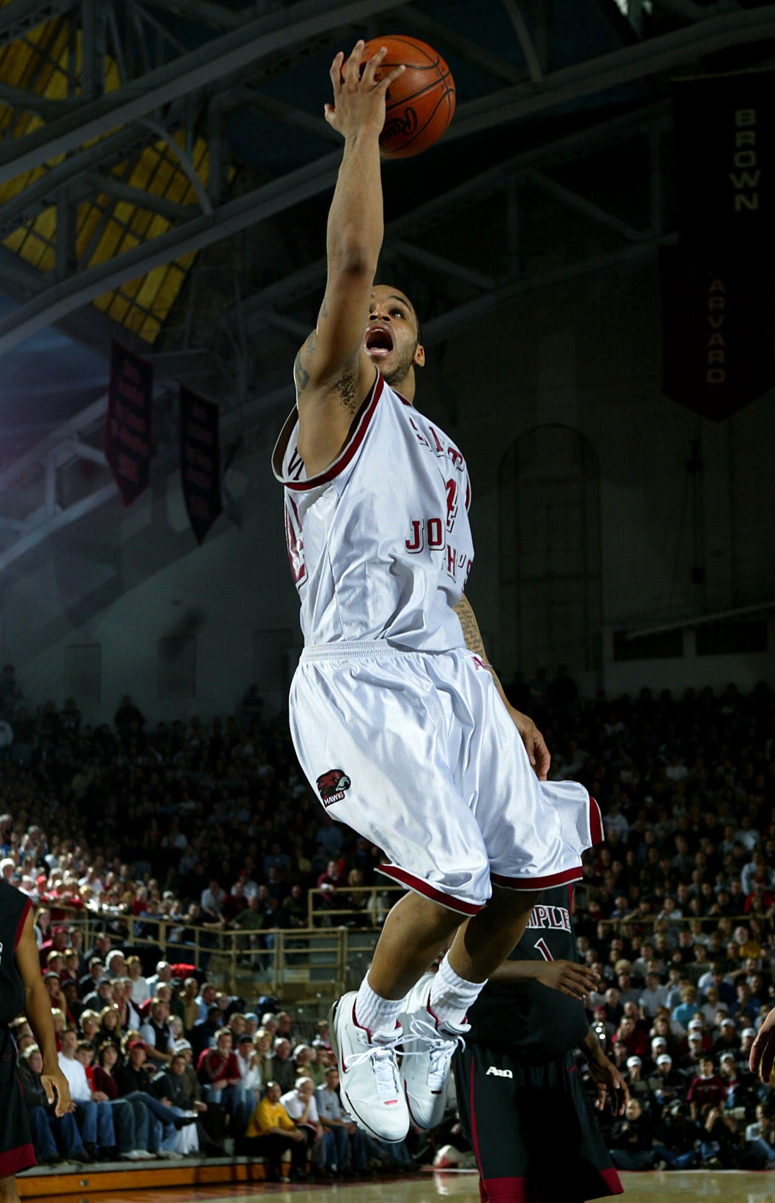 PHILADELPHIA - FEBRUARY 21:  Jameer Nelson #14 of the Saint Joseph's University Hawks goes to the basket against the Temple University Owls as the #2 Hawks defeated the Owls 76-53 during Atlantic 10 basketball action on February 21, 2004 at The Palestra i