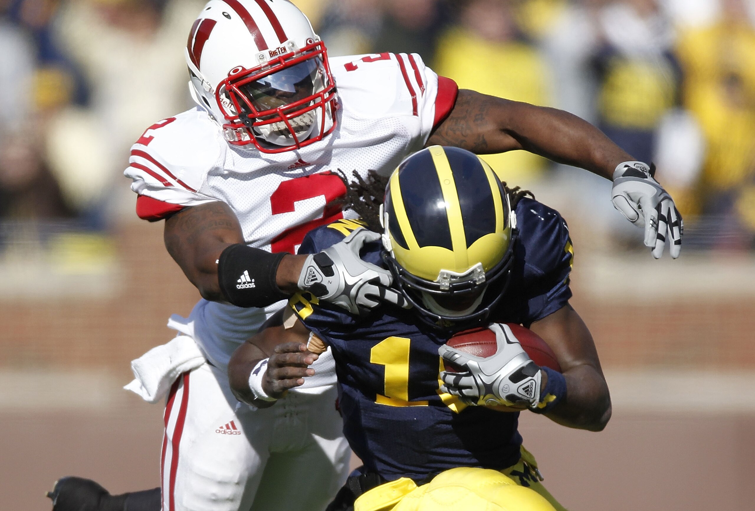 ANN ARBOR, MI - NOVEMBER 20: Jay Valai #2 of the Wisconsin Badgers tackles Denard Robinson #16 of the Michigan Wolverines at Michigan Stadium on November 20, 2010 in Ann Arbor, Michigan. (Photo by Gregory Shamus/Getty Images) ANN ARBOR, MI - NOVEMBER 20: Jay Valai #2 of the Wisconsin Badgers tackles Denard Robinson #16 of the Michigan Wolverines at Michigan Stadium on November 20, 2010 in Ann Arbor, Michigan. (Photo by Gregory Shamus/Getty Images)