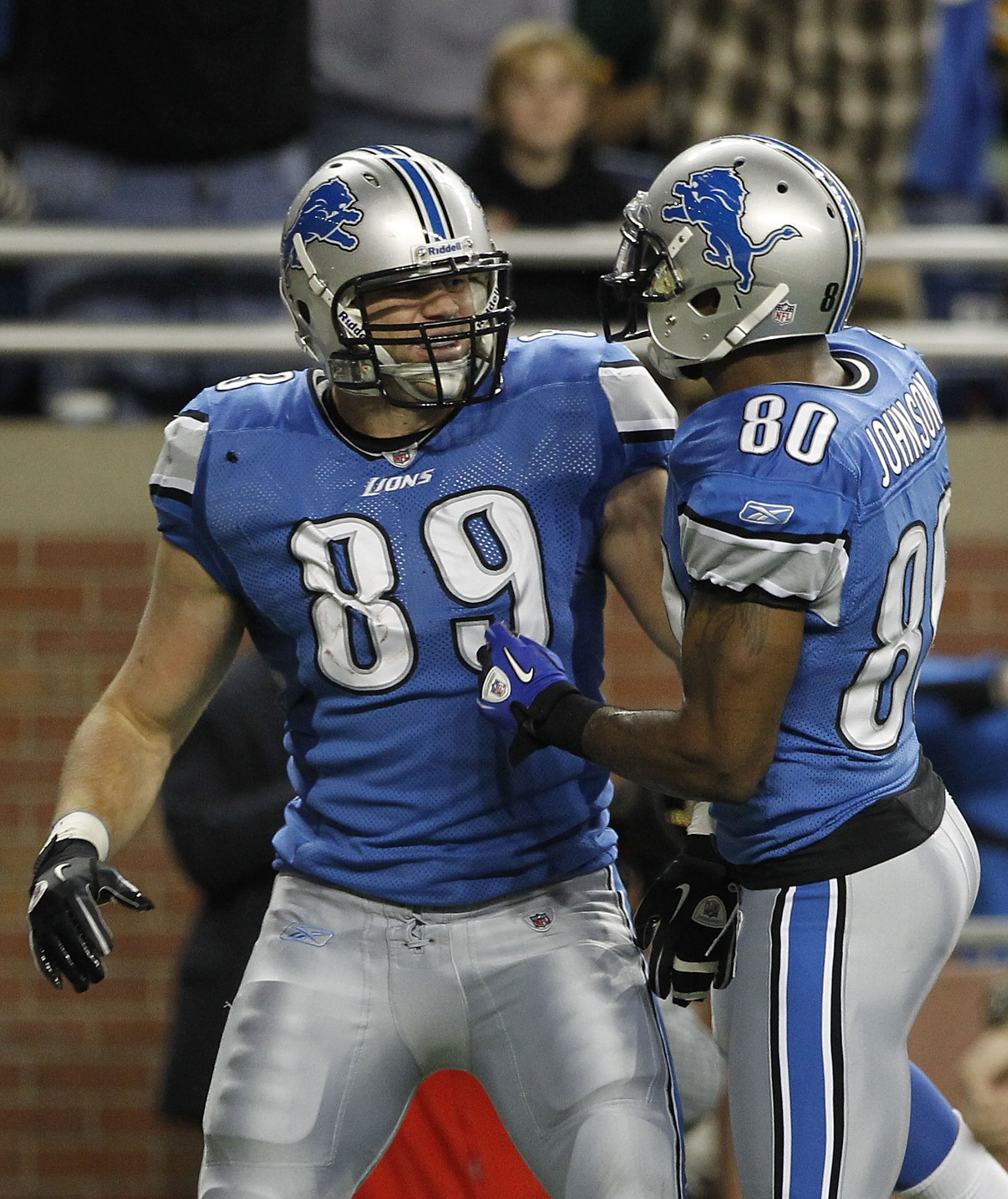 DETROIT - DECEMBER 12: Will Heller #89 of the Detroit Lions is congratulated by teammate Bryant Johnson #80 after scoring a fourth quarter touchdown during the game against the Green Bay Packers at Ford Field on December 12, 2010 in Detroit, Michigan. The