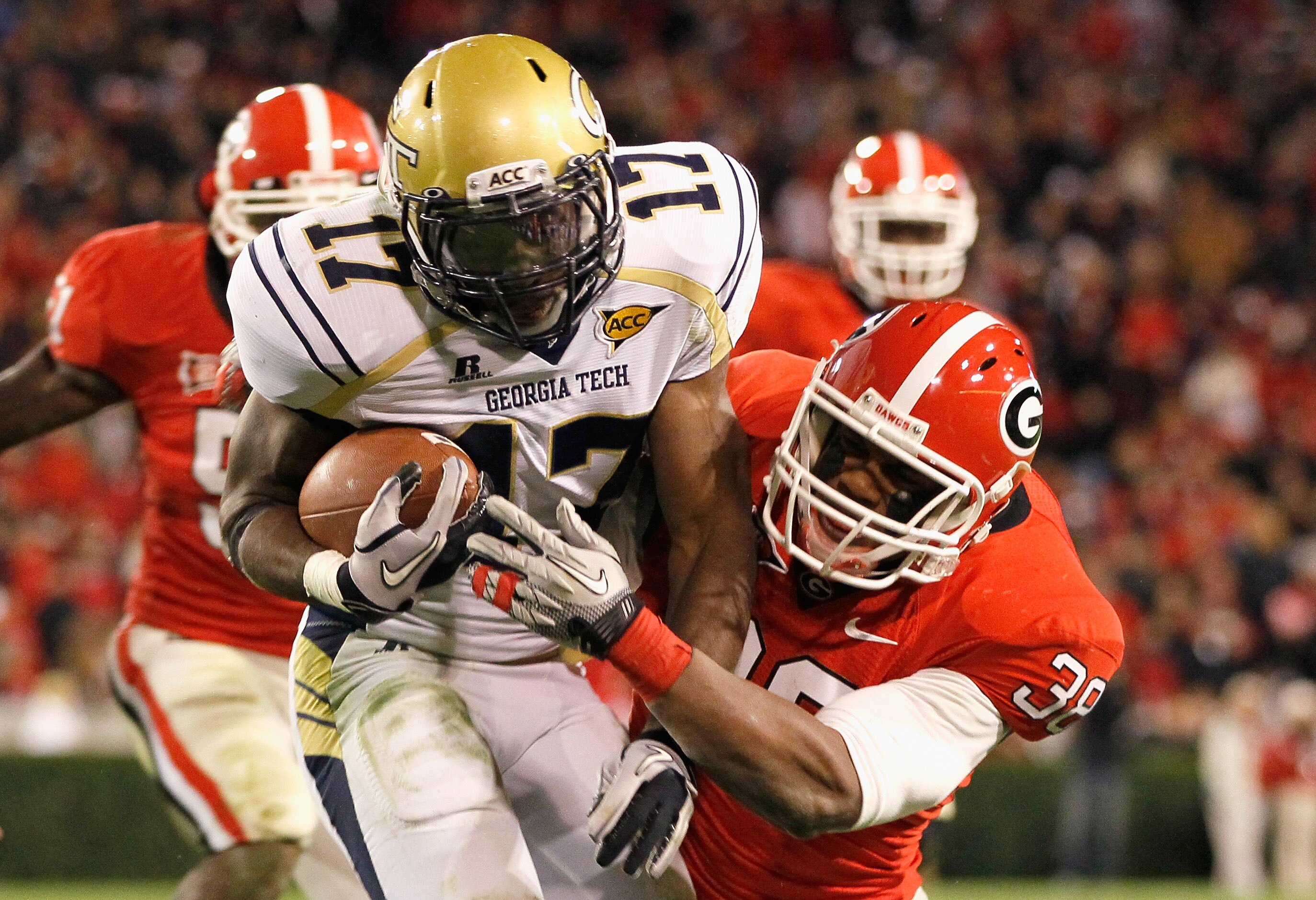 ATHENS, GA - NOVEMBER 27:  Marcus Dowtin #38 of the Georgia Bulldogs tackles Orwin Smith #17 of the Georgia Tech Yellow Jackets at Sanford Stadium on November 27, 2010 in Athens, Georgia.  (Photo by Kevin C. Cox/Getty Images)