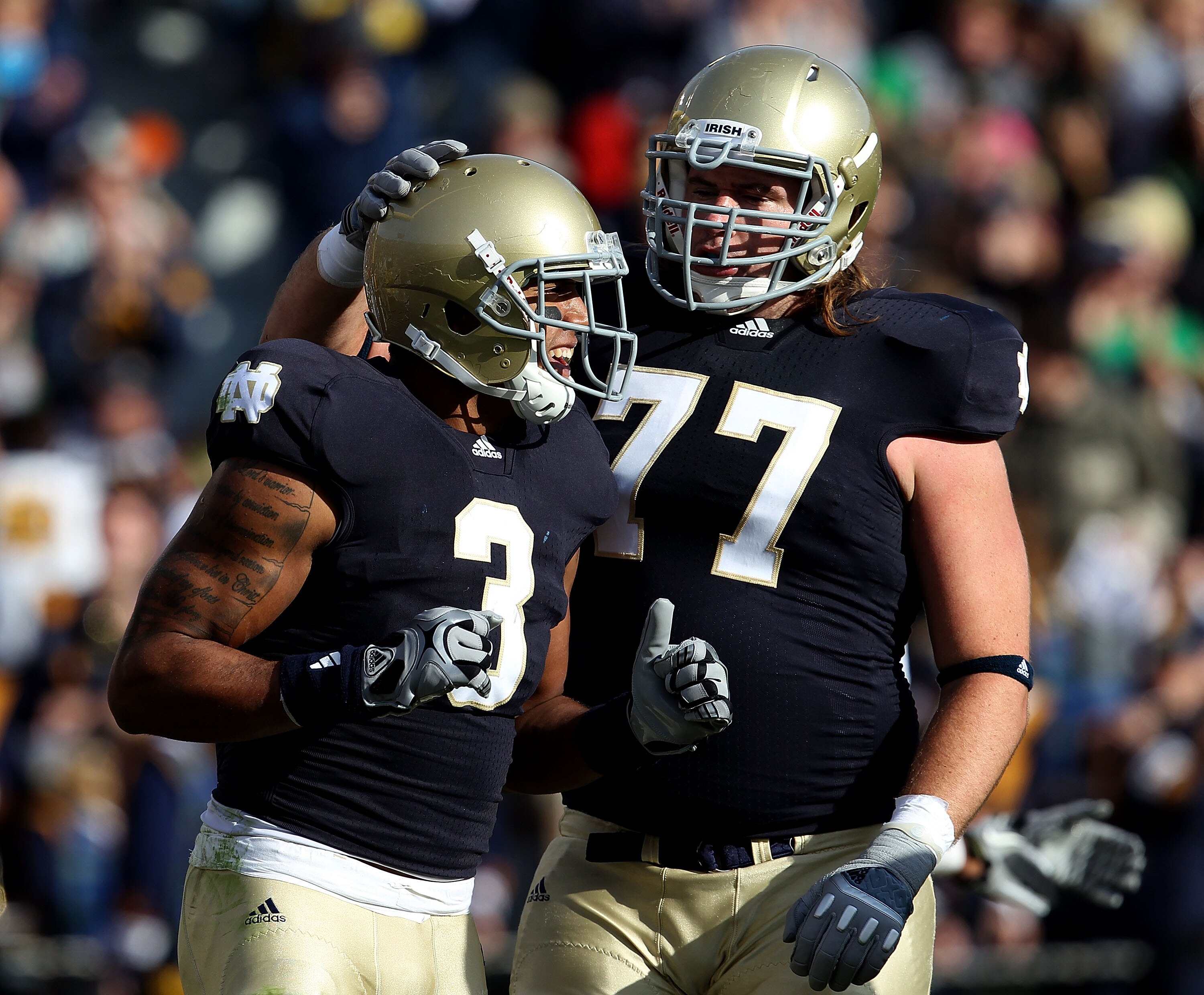 SOUTH BEND, IN - OCTOBER 30: Michael Floyd #3 and Matt Romine #77 of the Notre Dame Fighting Irish celebrate Floyd's touchdown catch against the Tulsa Golden Hurricane at Notre Dame Stadium on October 30, 2010 in South Bend, Indiana. (Photo by Jonathan Da
