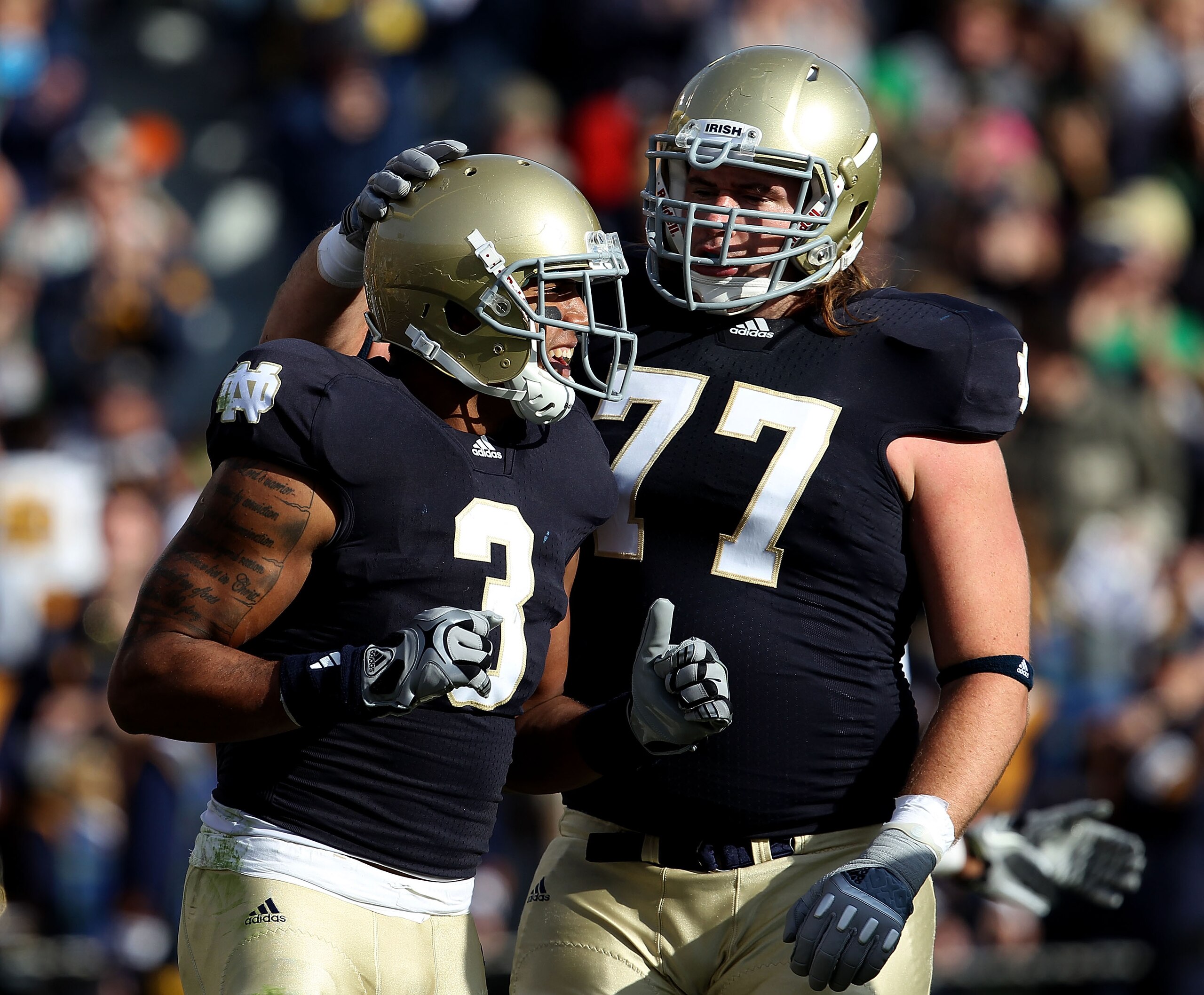 SOUTH BEND, IN - OCTOBER 30: Michael Floyd #3 and Matt Romine #77 of the Notre Dame Fighting Irish celebrate Floyd's touchdown catch against the Tulsa Golden Hurricane at Notre Dame Stadium on October 30, 2010 in South Bend, Indiana. (Photo by Jonathan Da