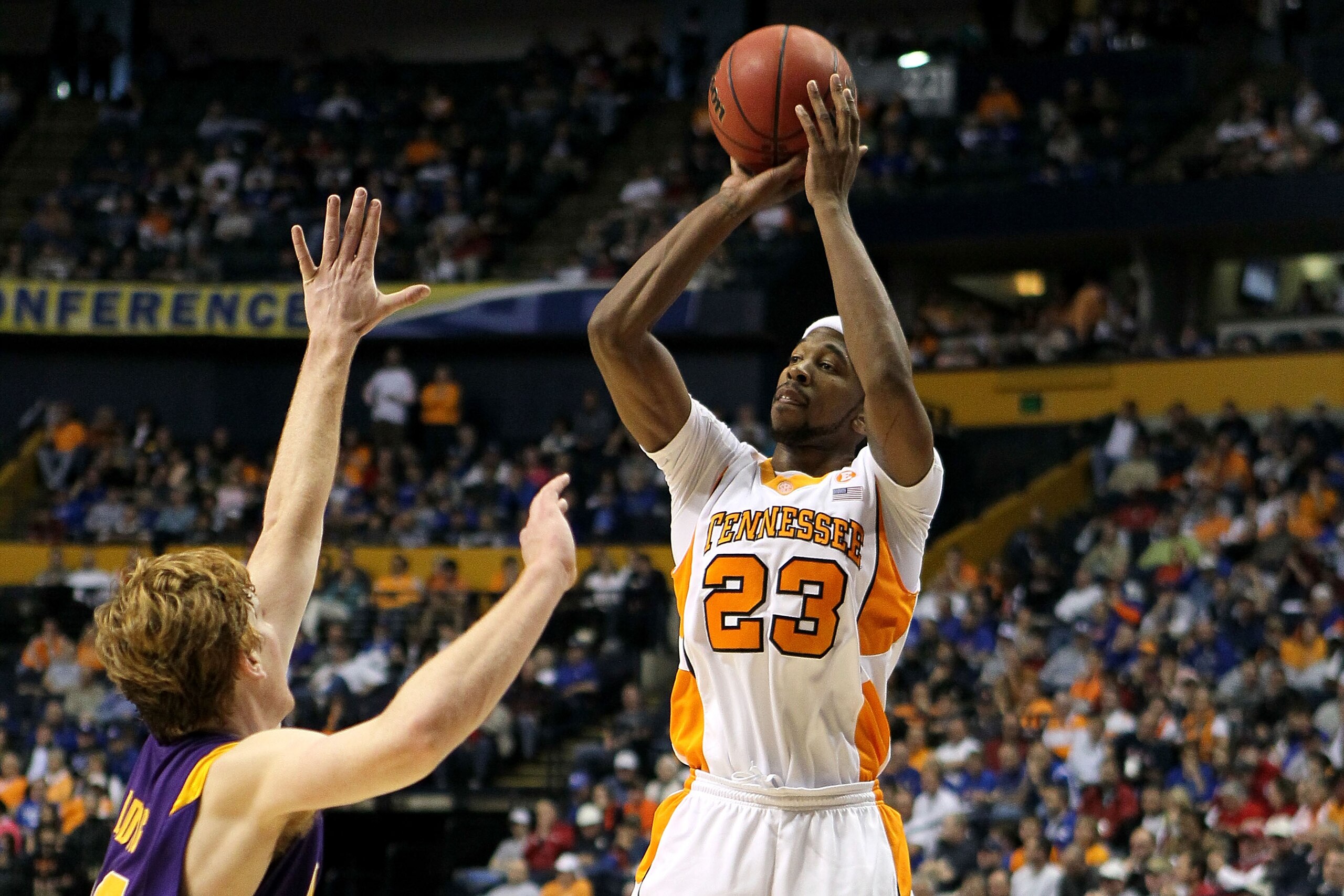 NASHVILLE, TN - MARCH 11:  Cameron Tatum #23 of the Tennessee Volunteers attempts a shot against Eddie Ludwig #13 of the LSU Tigers during the first round of the SEC Men's Basketball Tournament at the Bridgestone Arena on March 11, 2010 in Nashville, Tenn