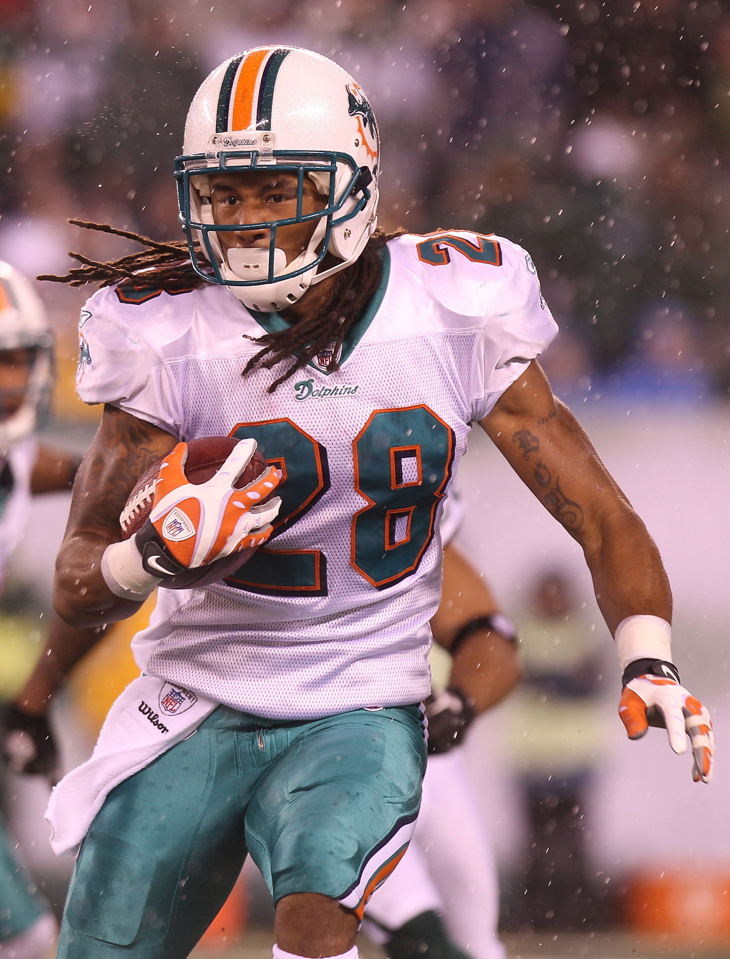 EAST RUTHERFORD, NJ - DECEMBER 12:  Nolan Carroll #28 of the Miami Dolphins rushes against the New York Jets at New Meadowlands Stadium on December 12, 2010 in East Rutherford, New Jersey.  (Photo by Nick Laham/Getty Images)