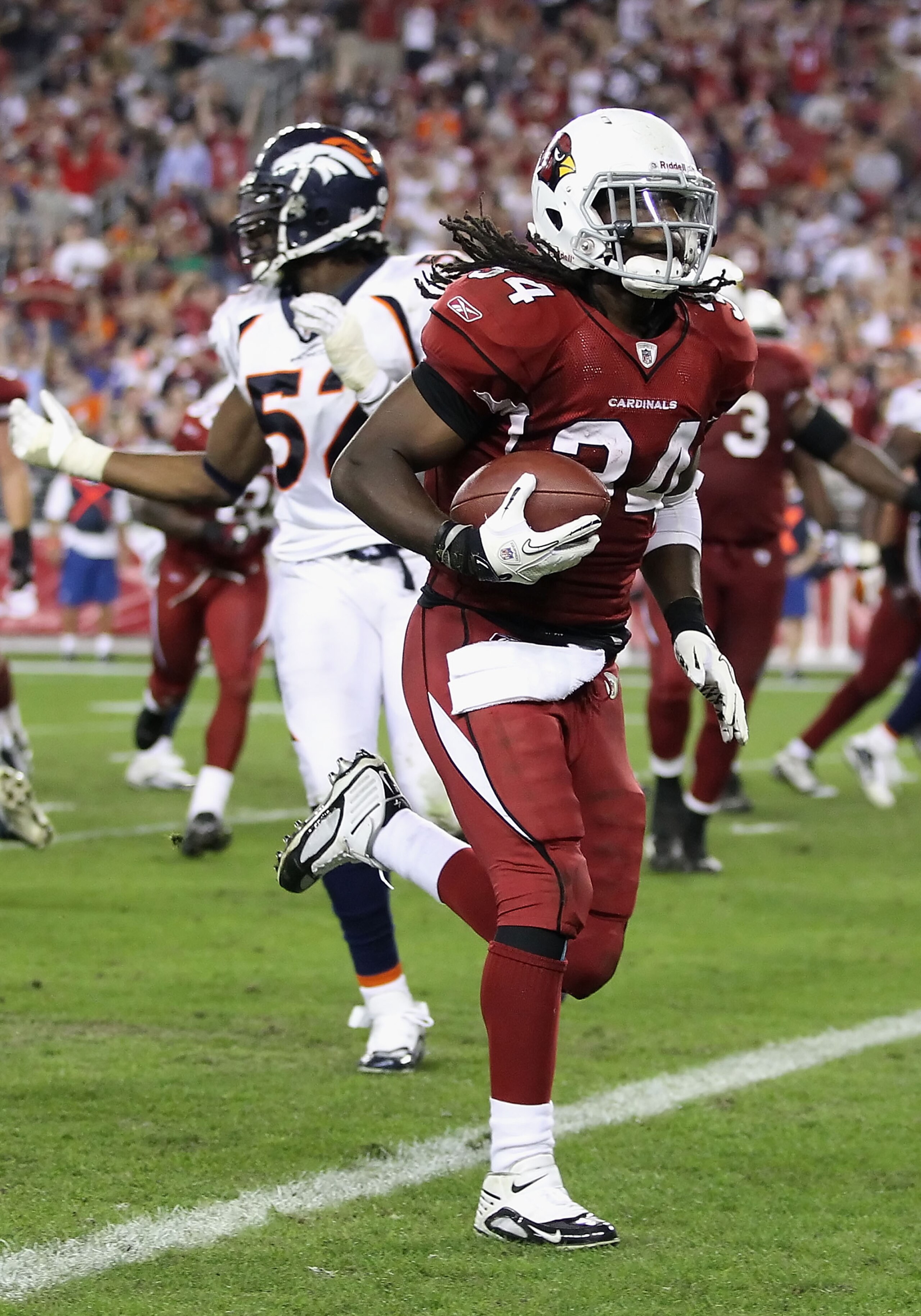 GLENDALE, AZ - DECEMBER 12:  Runningback Tim Hightower #34 of the Arizona Cardinals scores a 8 yard rushing touchdown against the Denver Broncos during the fourth quarter of the NFL game at the University of Phoenix Stadium on December 12, 2010 in Glendal