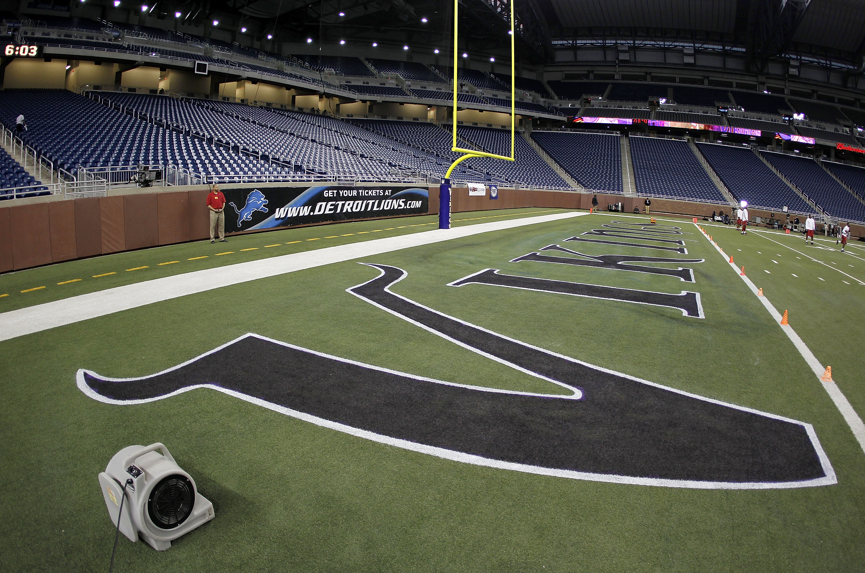 DETROIT, MI - DECEMBER 13:  Fans dry new logos painted on the field prior to the Minnesota Vikings playing the New York Giants at Ford Field on December 13, 2010 in Detroit, Michigan.  (Photo by Gregory Shamus/Getty Images)