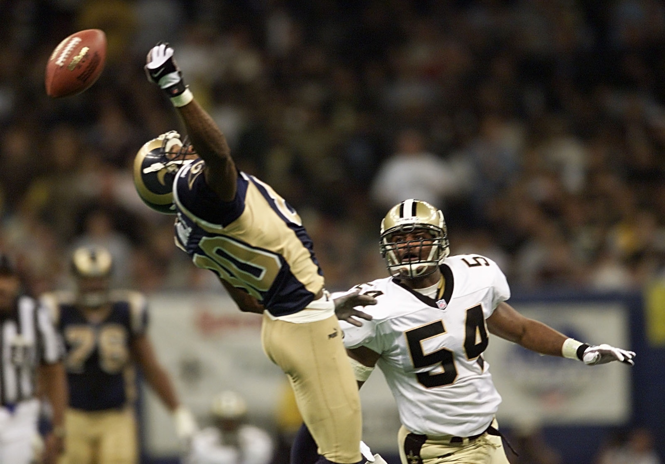 30 Dec 2000:  Linebacker Darrin Smith #54 of the New Orleans Saints watches as the ball bounces off the hand of Isaac Bruce #80 of the St. Louis Rams in the third quarter at the Superdome in New Orleans, Louisiana.  The Saints upset the Rams 31-28 in the
