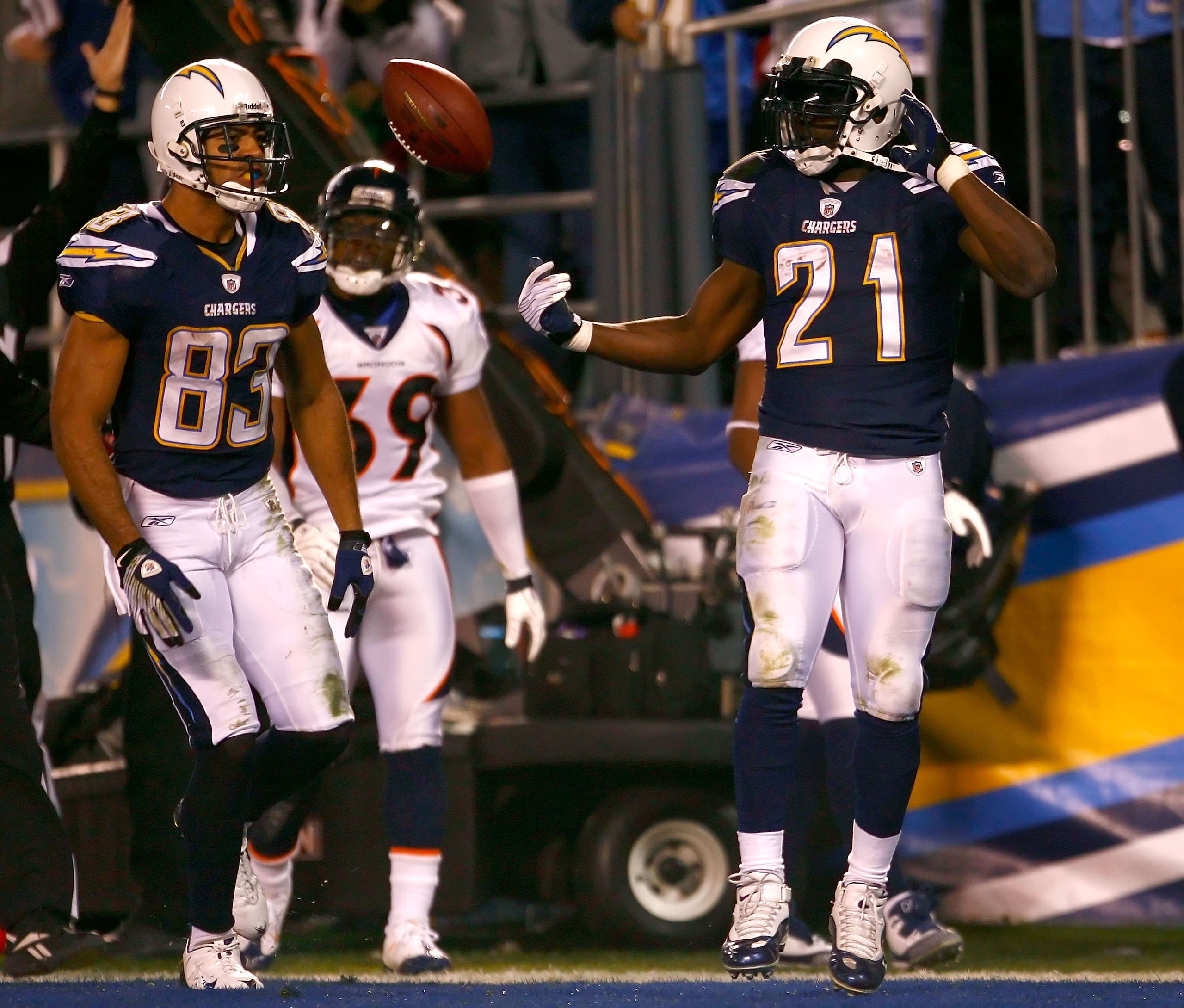 SAN DIEGO - DECEMBER 28:  Runningback LaDainian Tomlinson #21 of the San Diego Chargers flips the ball to teammate Vincent Jackson #83 after Tomlinson scored a 14 yard rushing touchdown against the Denver Broncos during the third quarter of the NFL game a