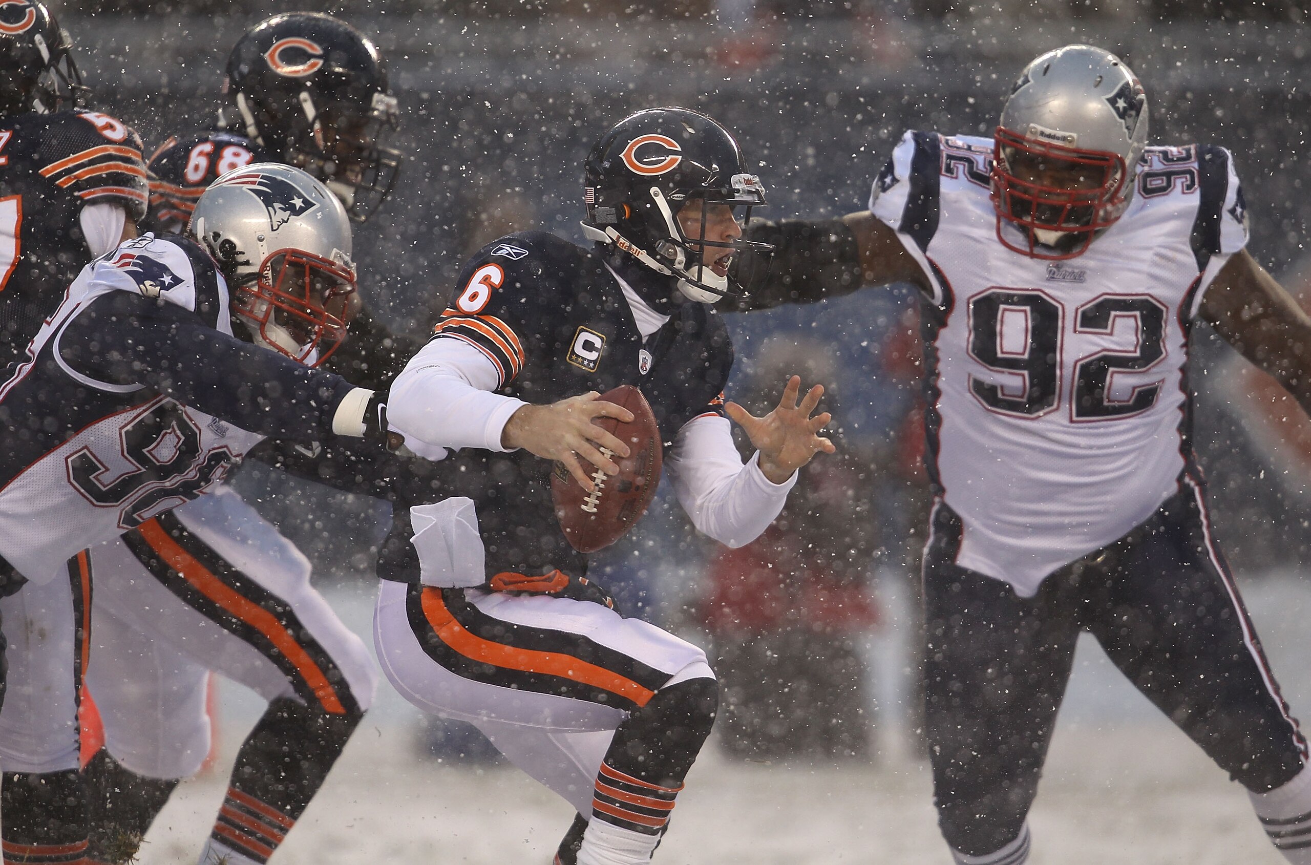 CHICAGO, IL - DECEMBER 12: Jay Cutler #6 of the Chicago Bears tries to avoid Eric Moore #98 and Gerard Warren #92 of the New England Patriots at Soldier Field on December 12, 2010 in Chicago, Illinois.  The Patriots defeated the Bears 36-7.  (Photo by Jon