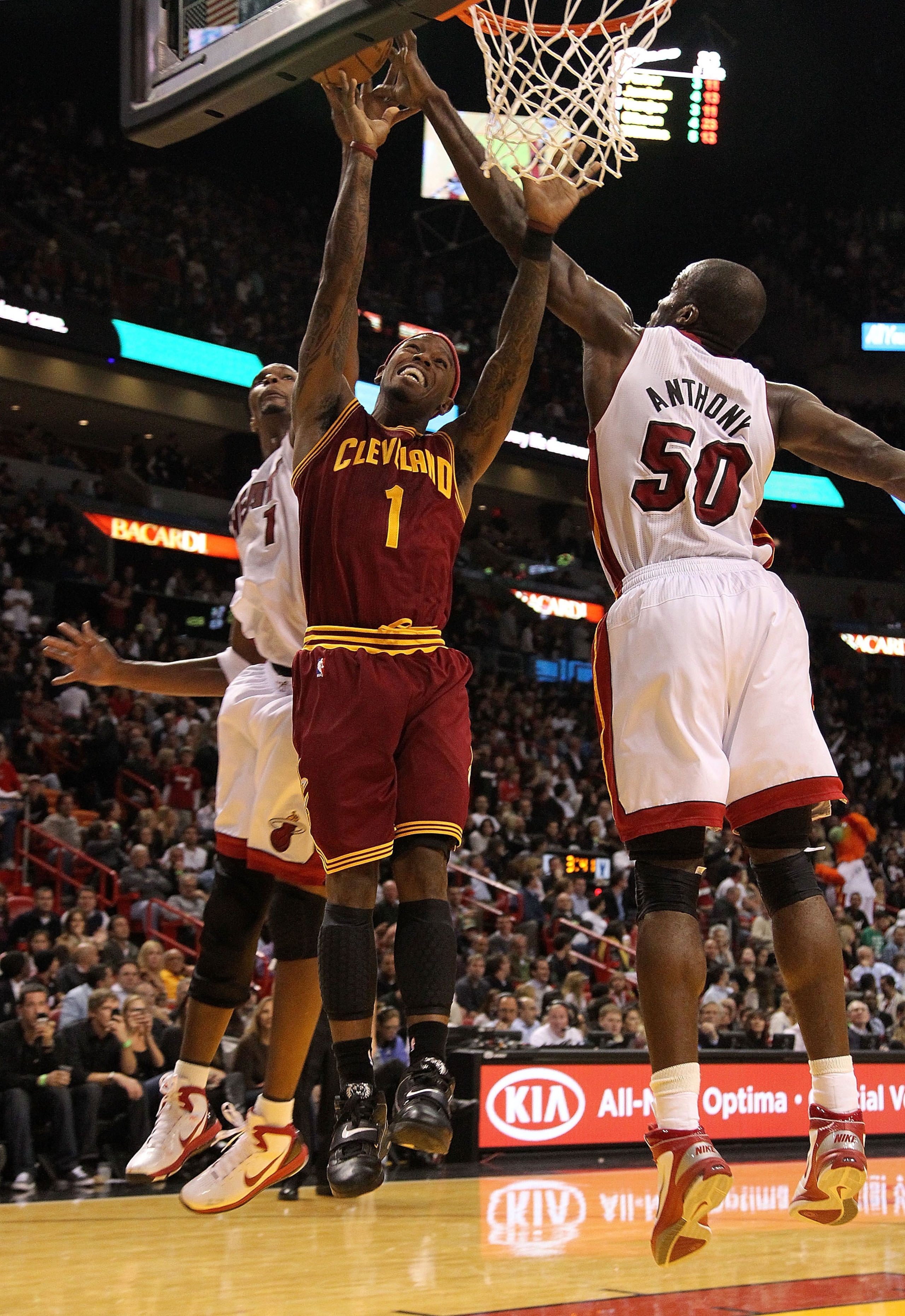 MIAMI, FL - DECEMBER 15:  Daniel Gibson #1 of the Cleveland Cavaliers is fouled by  Joel Anthony #50 of the Miami Heat during a game at American Airlines Arena on December 15, 2010 in Miami, Florida. NOTE TO USER: User expressly acknowledges and agrees th